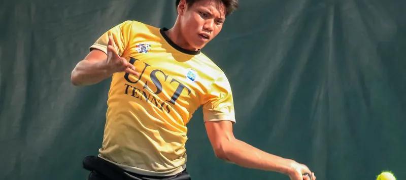 A tennis player striking a ball on court