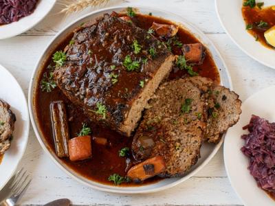 Sliced homemade meatloaf with glaze on a cutting board
