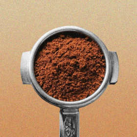 A portafilter filled with coffee grounds