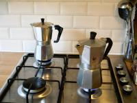 The Bialetti Moka Express and the Pezzetti Italexpress side by side on a gas hob. 