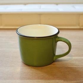 A minimalistic green enamel and ceramic mug.