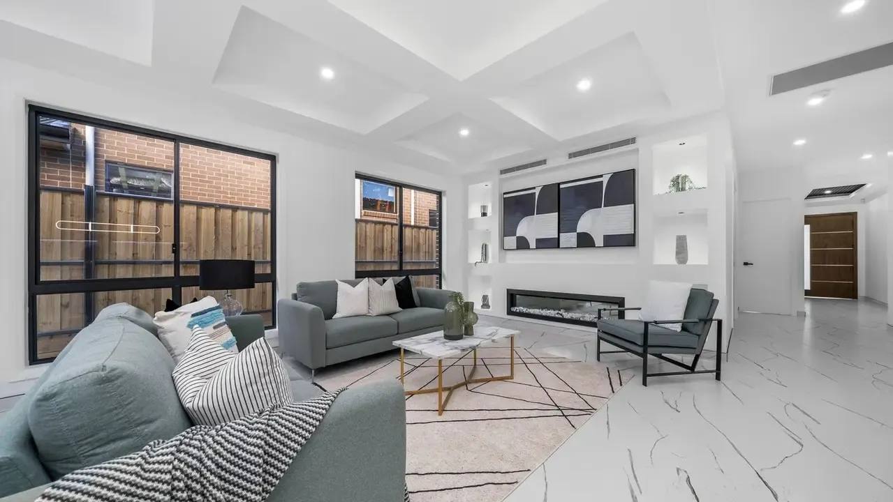 Modern living room with feature fireplace, recessed ceiling and large windows.