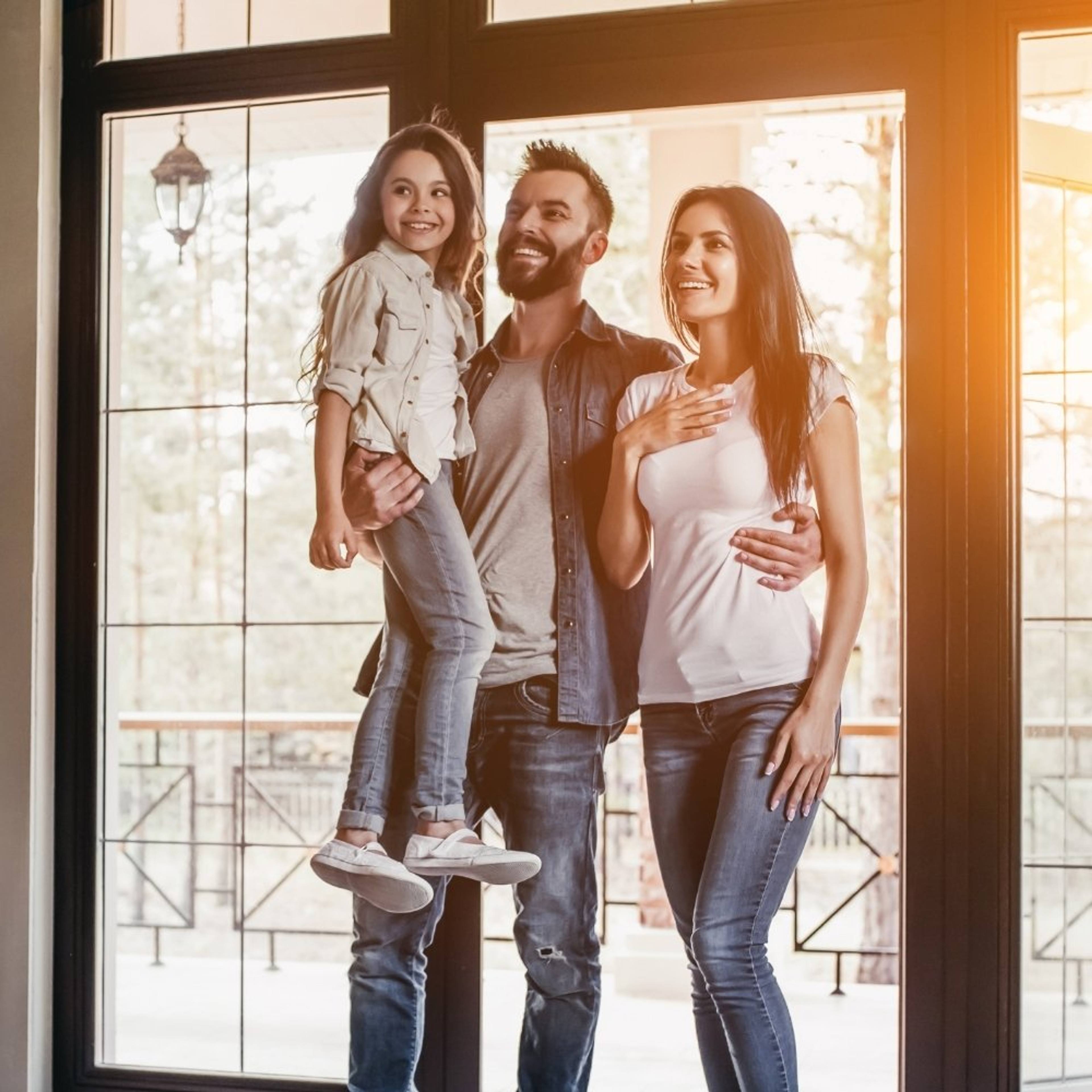 Happy family standing inside their newly completed Homesquare home in Adelaide.