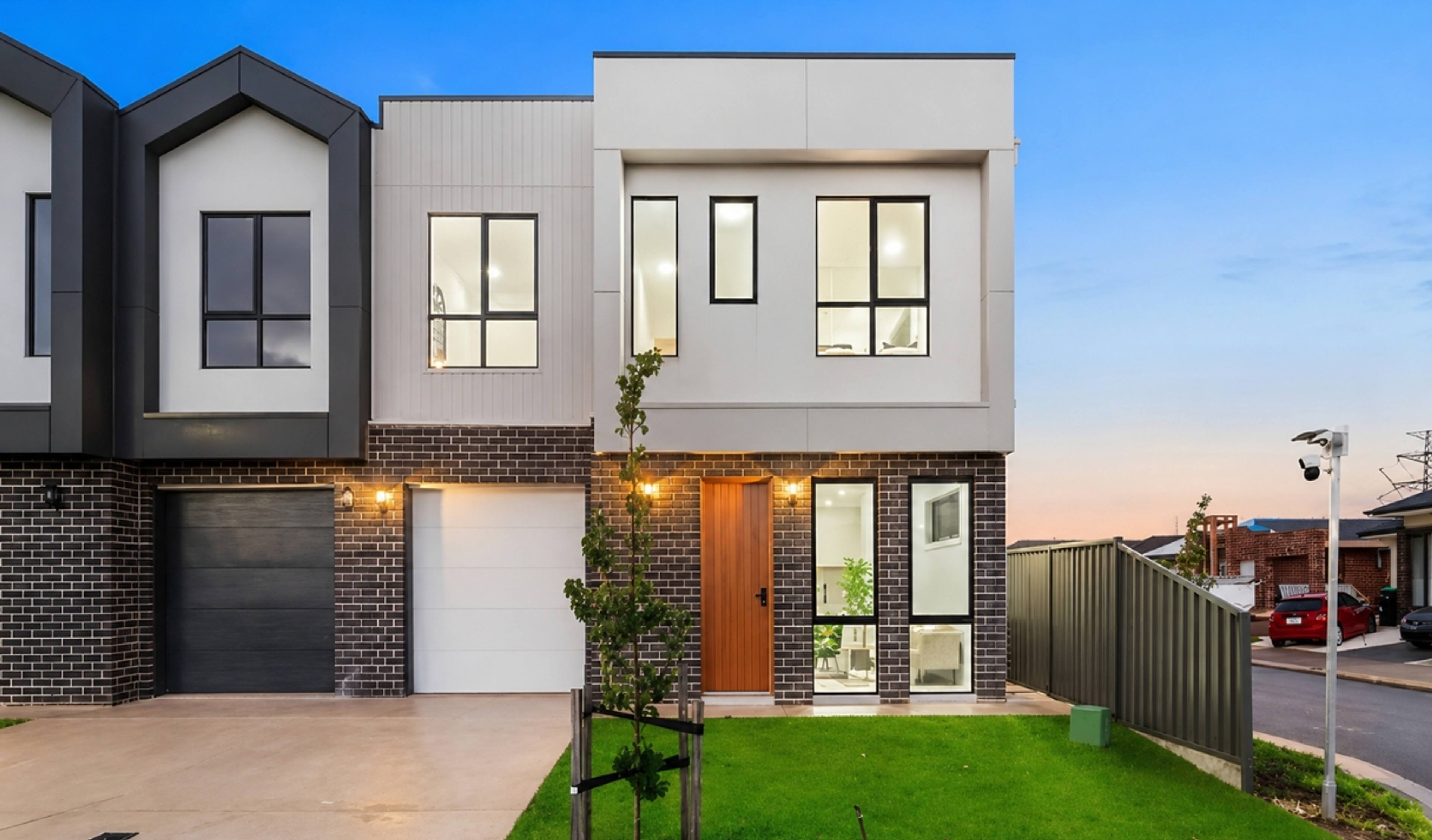Modern double-storey townhouse with a contemporary façade and single garage.
