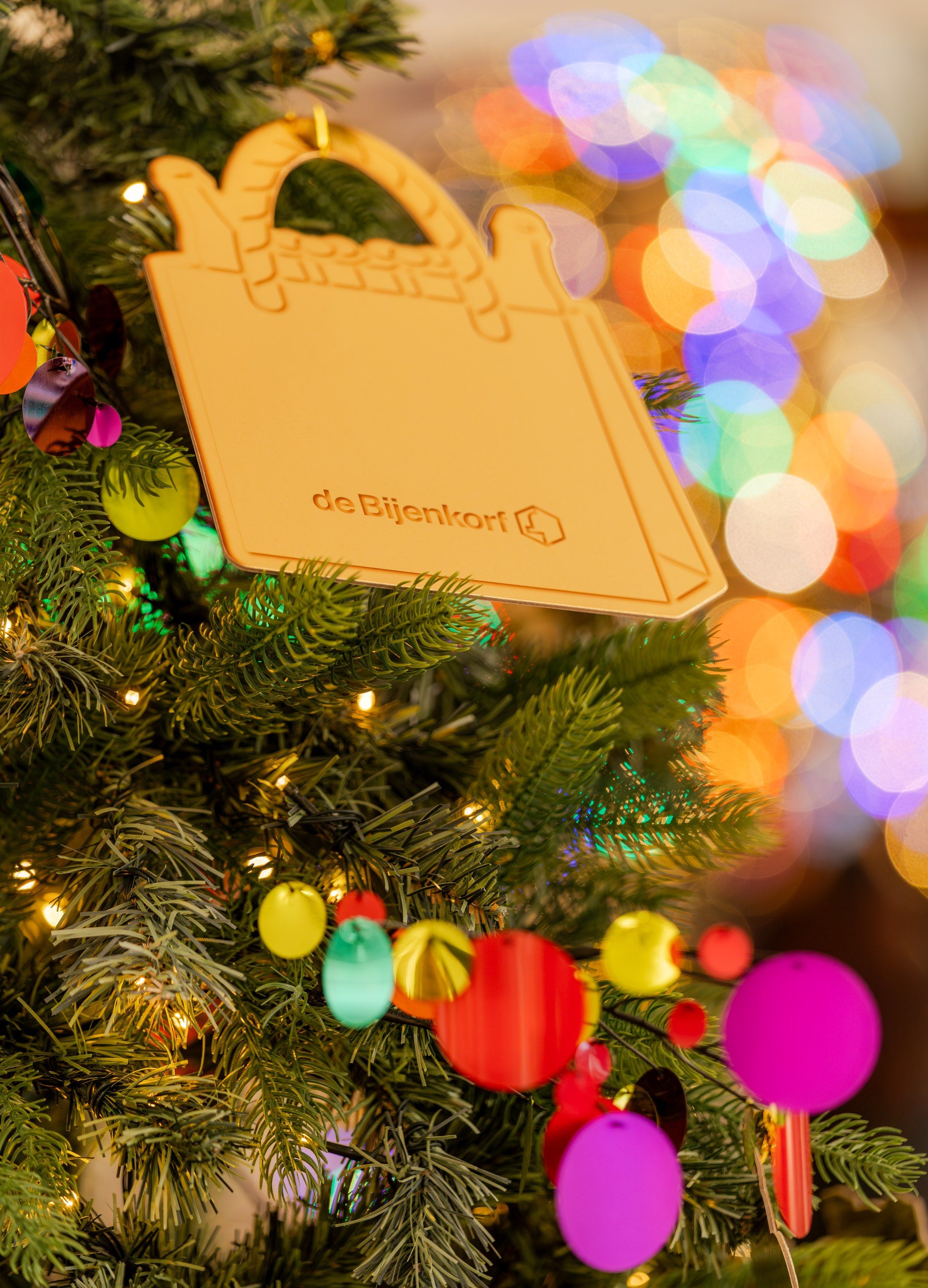 Gouden ornament in de vorm van een tas in de kerstboom van De Bijenkorf