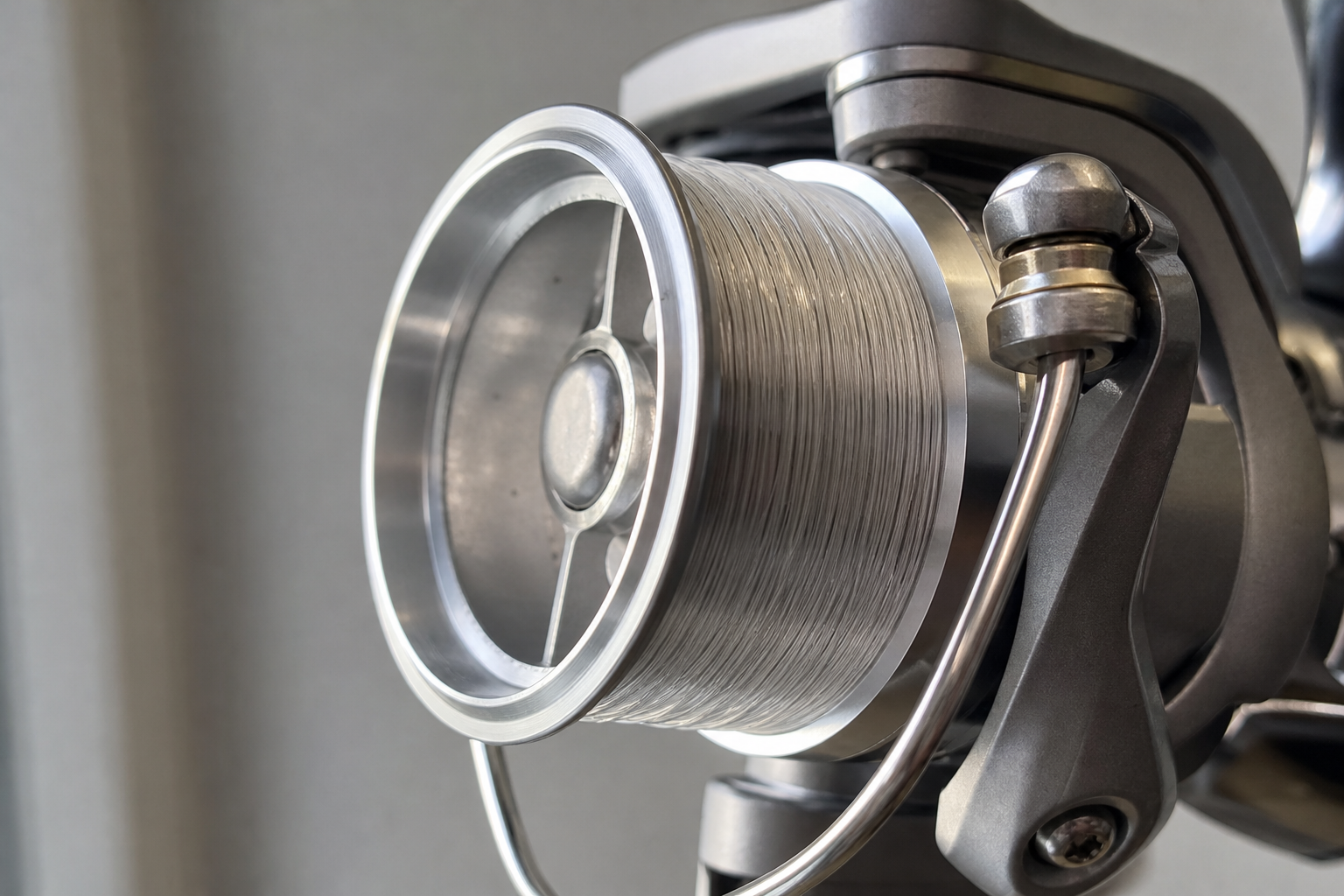 Close-up of a shallow match spool on a fixed-spool reel, wound neatly with fine monofilament line