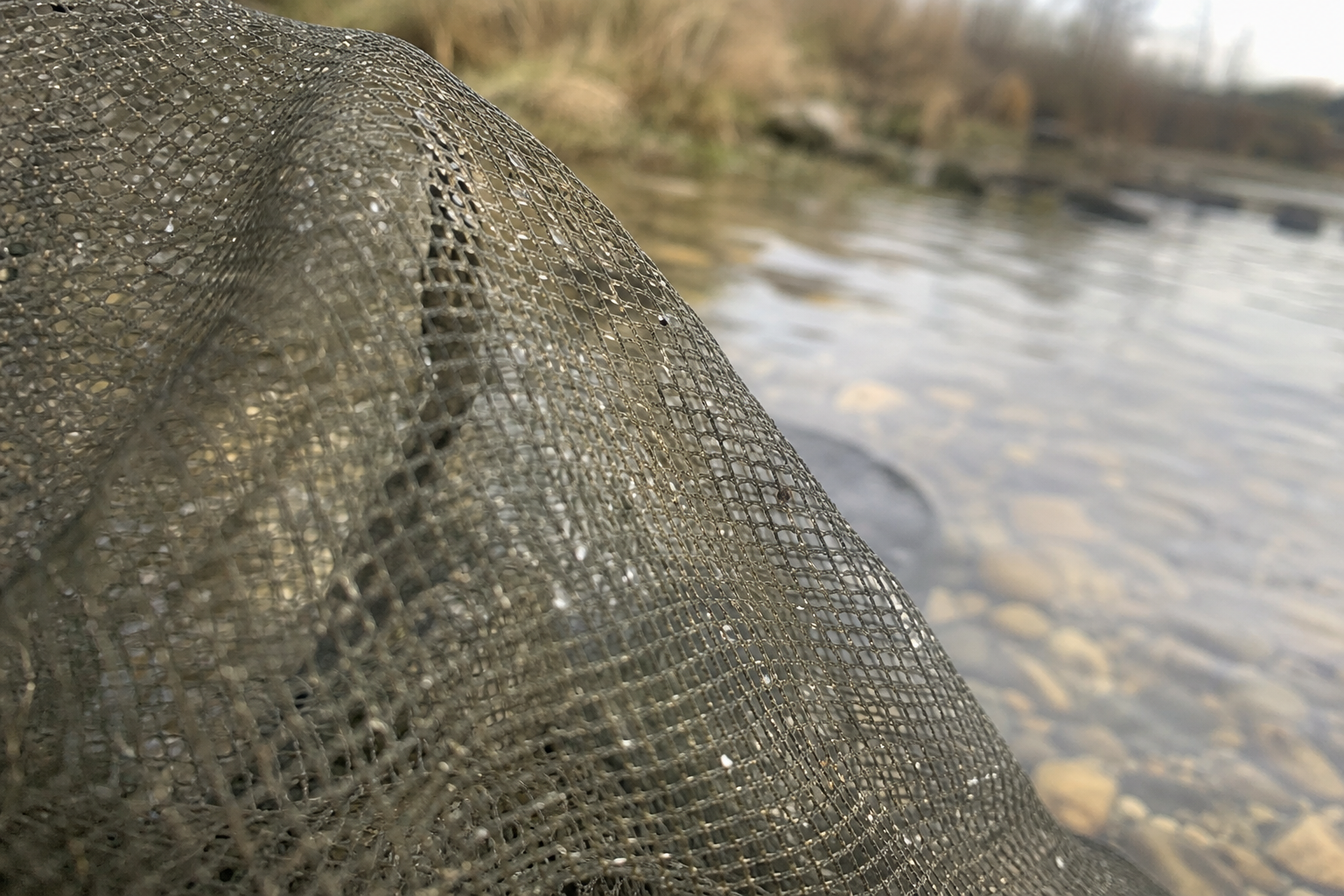Close-up of soft knotless mesh on a keepnet, showing fine even weave