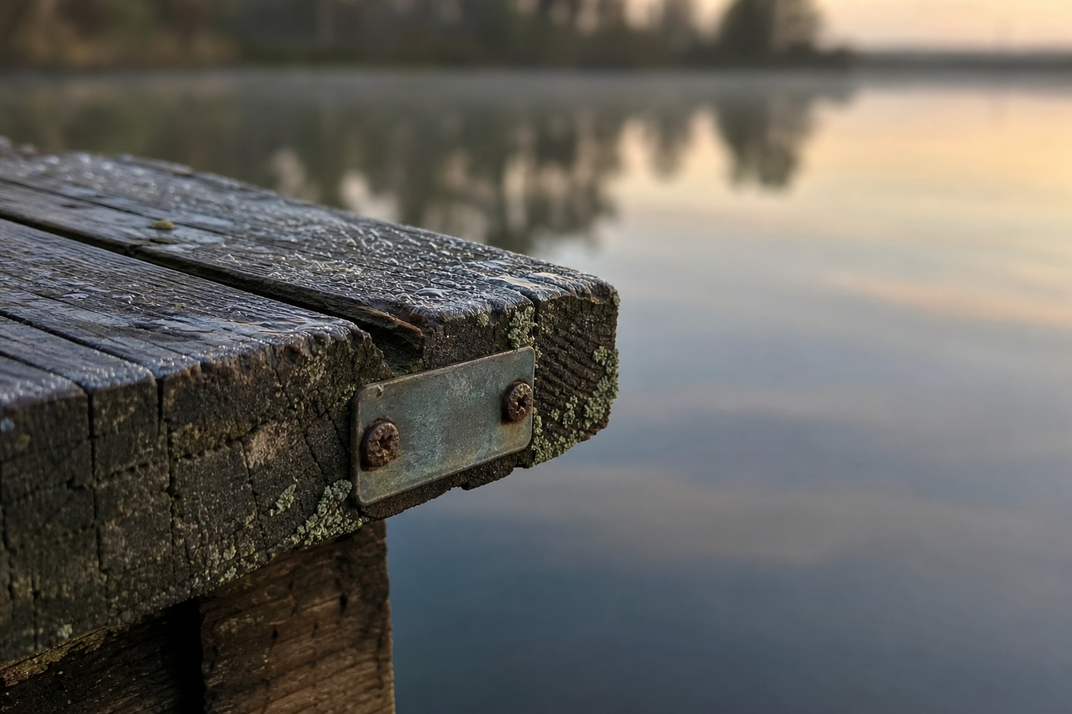 Close-up of a numbered wooden fishing platform beside calm still water