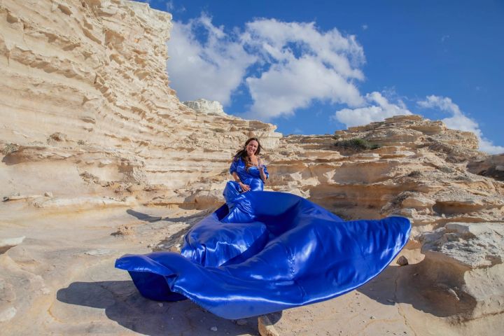 Flying dress photography in a blue dress on the Cyprus coast