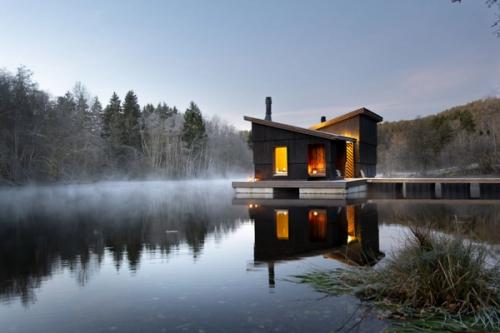 Floating sauna on misty lake