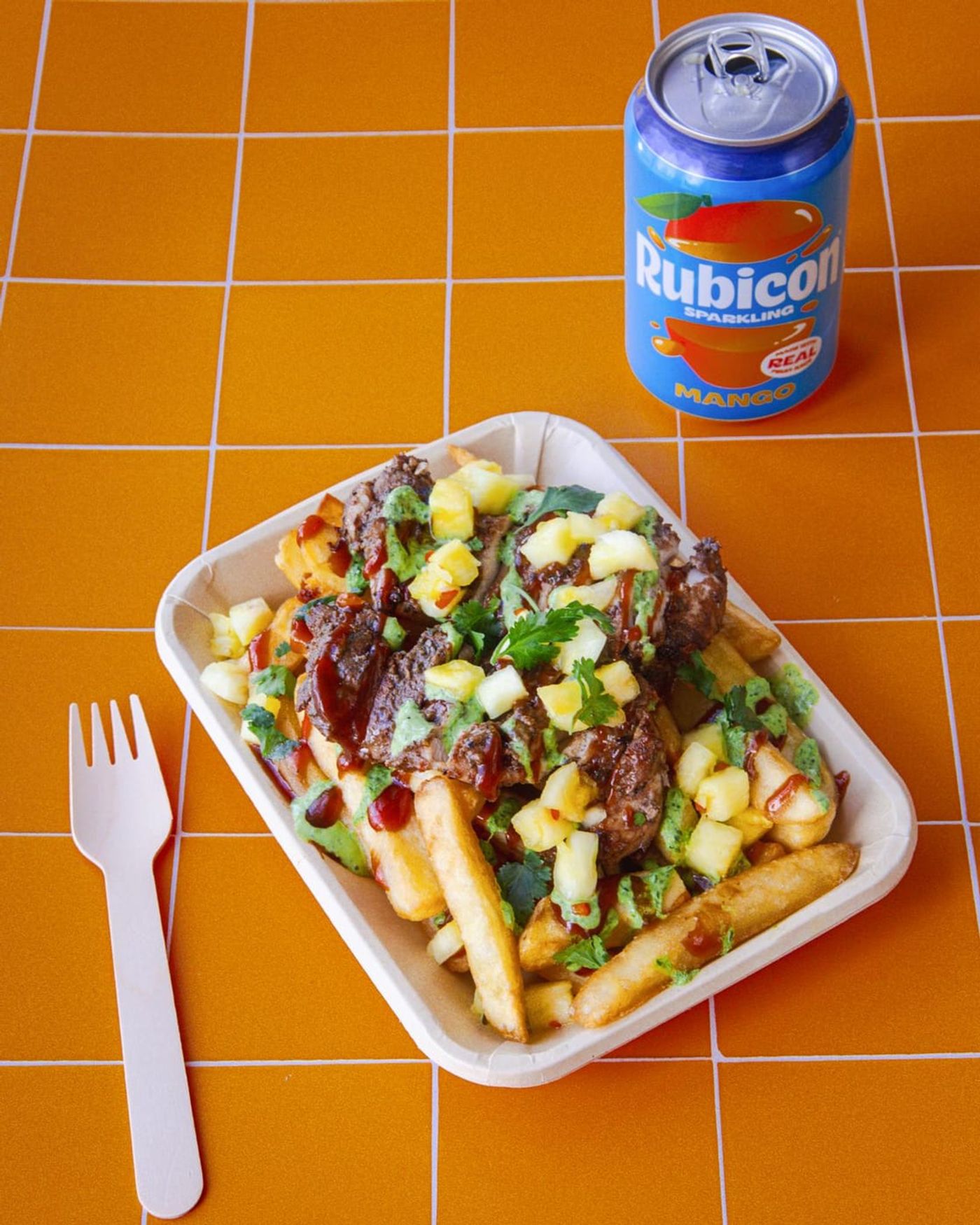 Loaded jerk fries with mango salsa and a fork