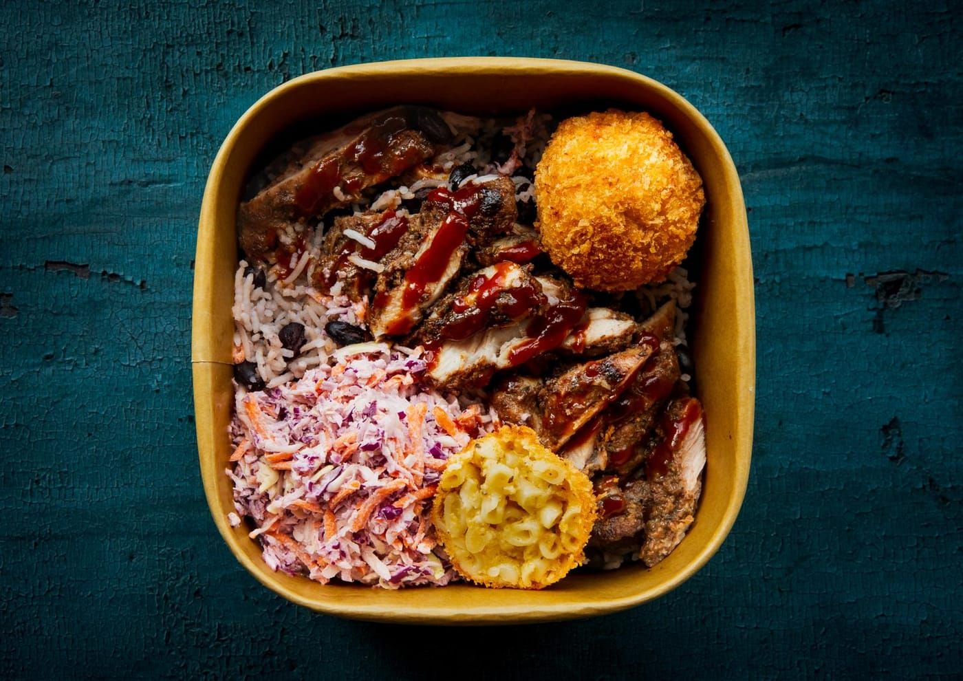 Jerk chicken rice bowl with coleslaw and a mac and cheese bite