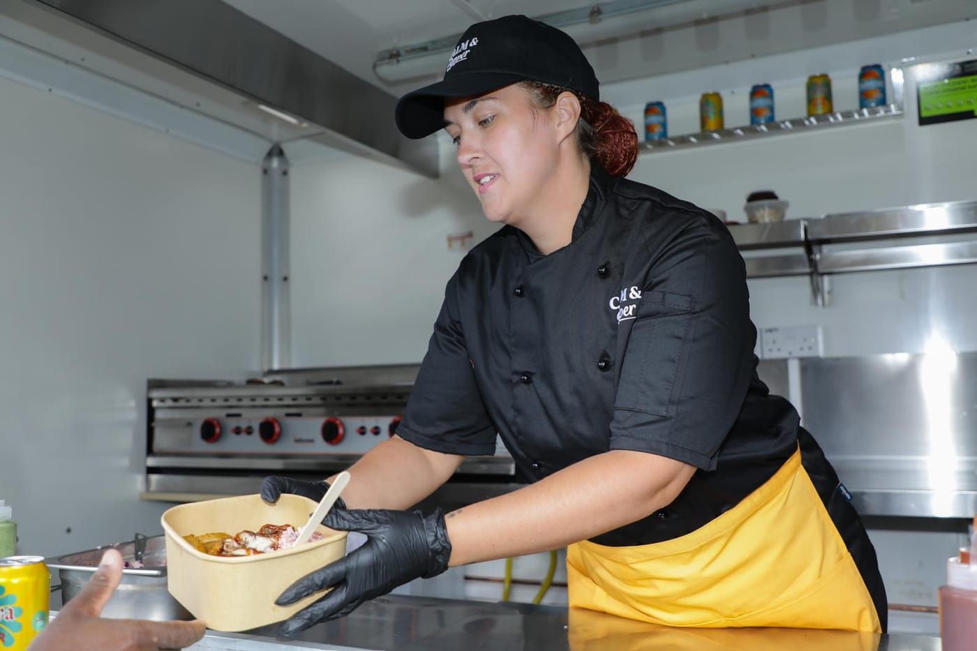 Chef plating up a rice bowl in the trailer