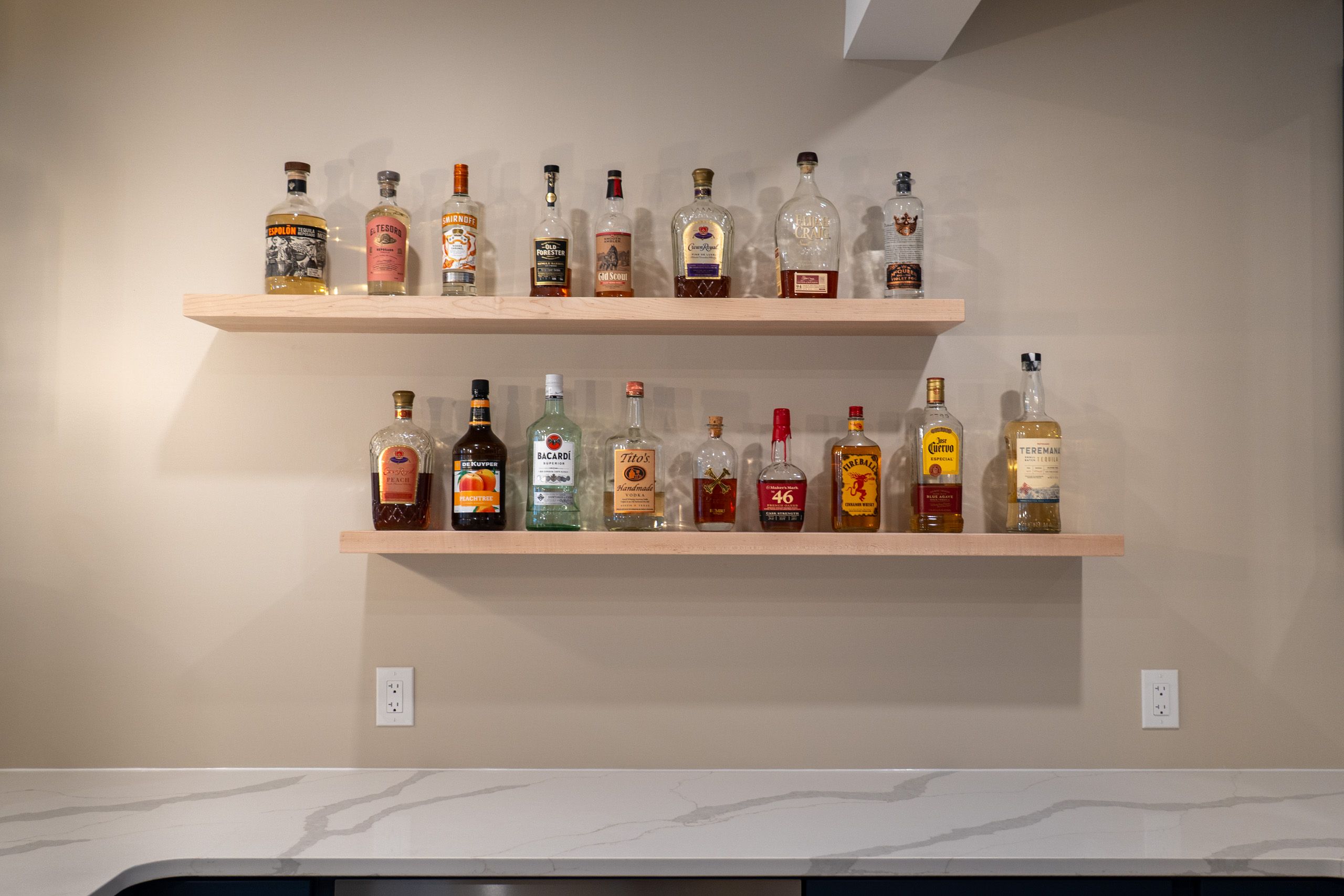 Floating shelves with liquor bottles