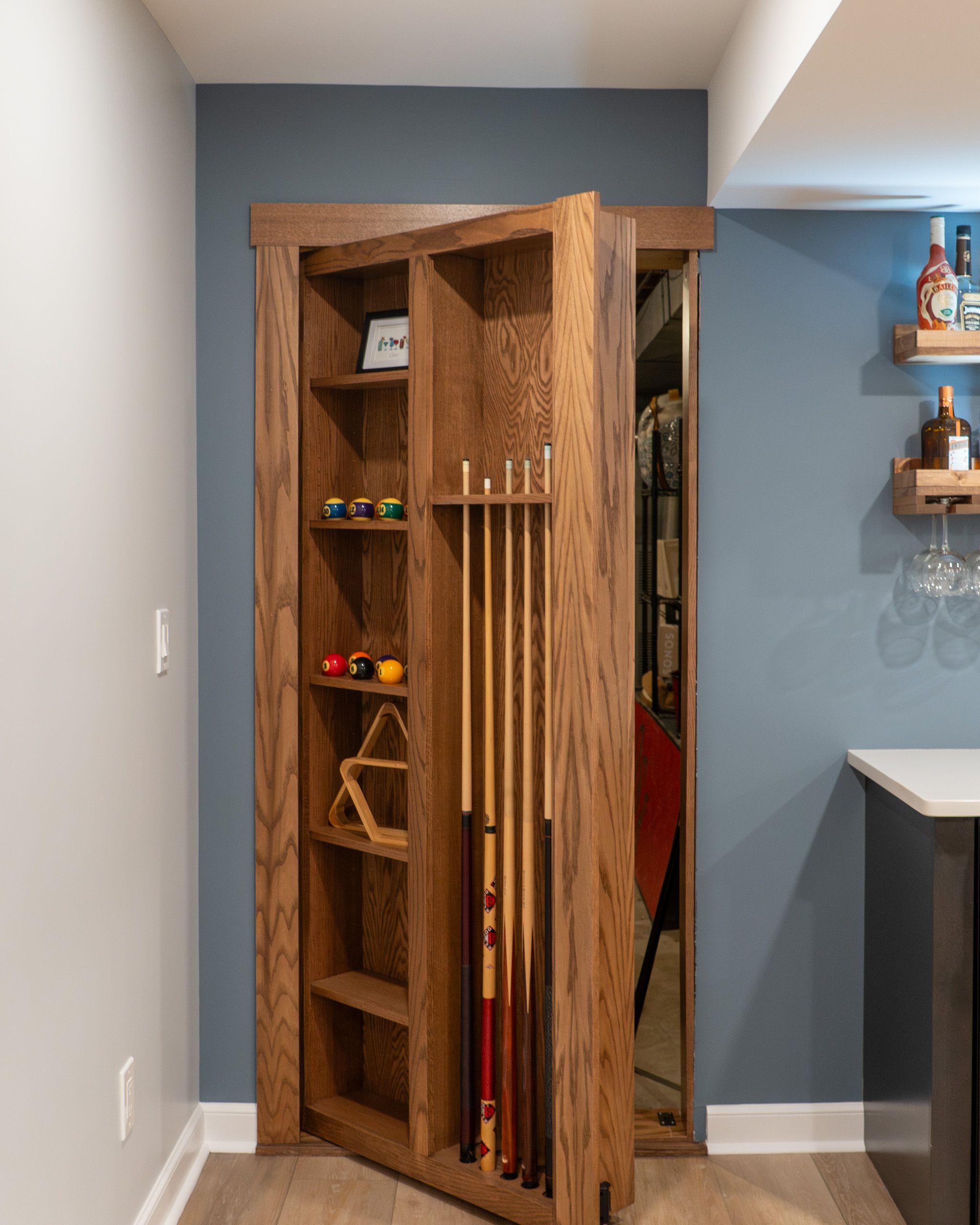 Pool cue rack hidden door