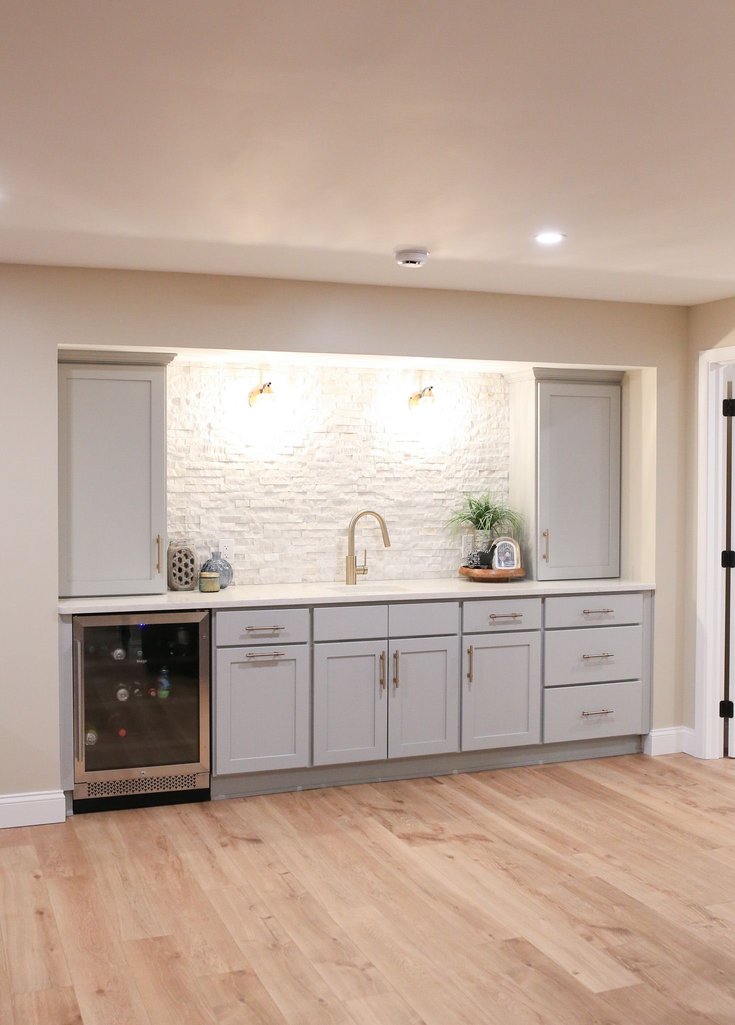 wide shot of wet bar with grey cabinets