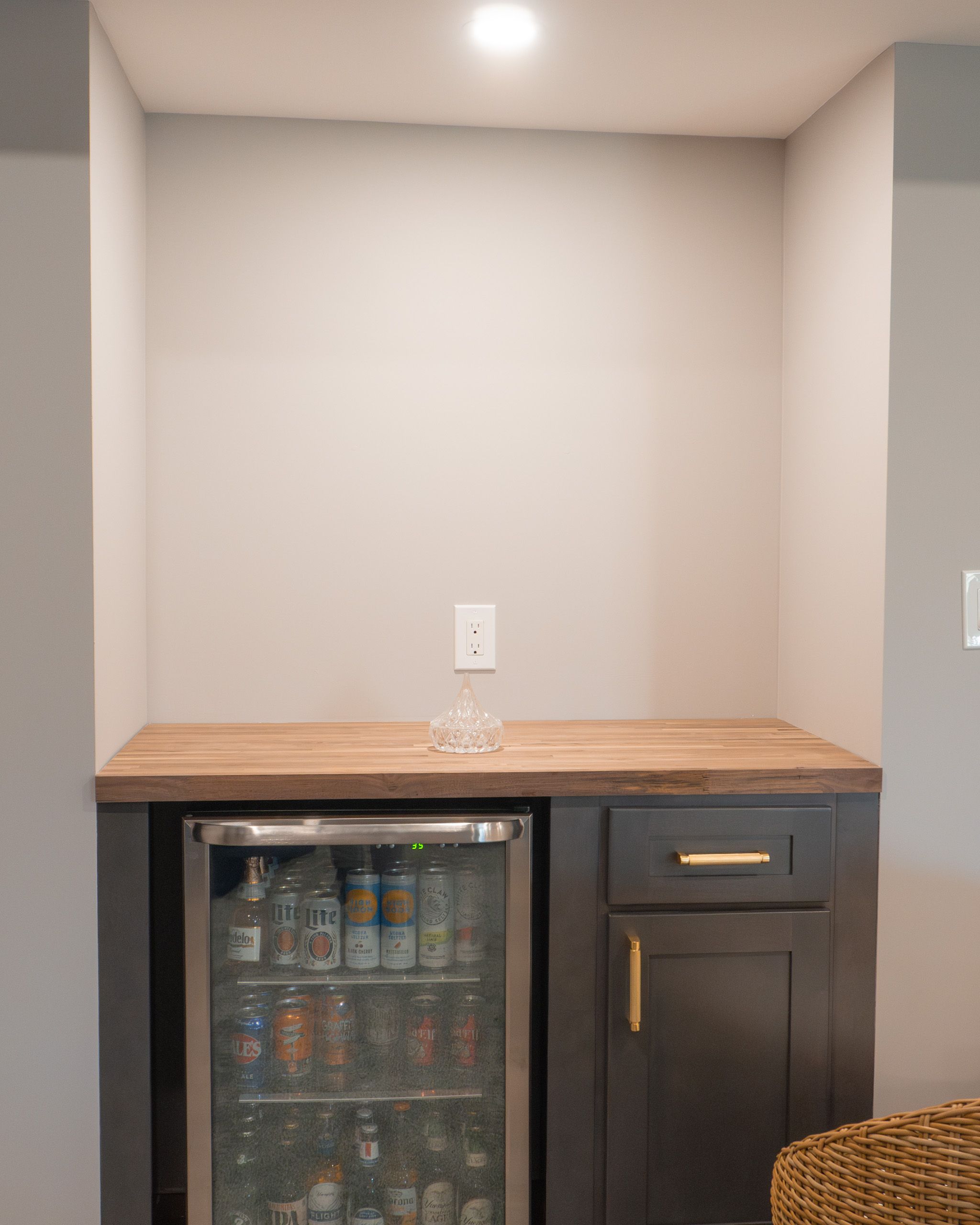 Dry bar with butcher block countertop and grey cabinets