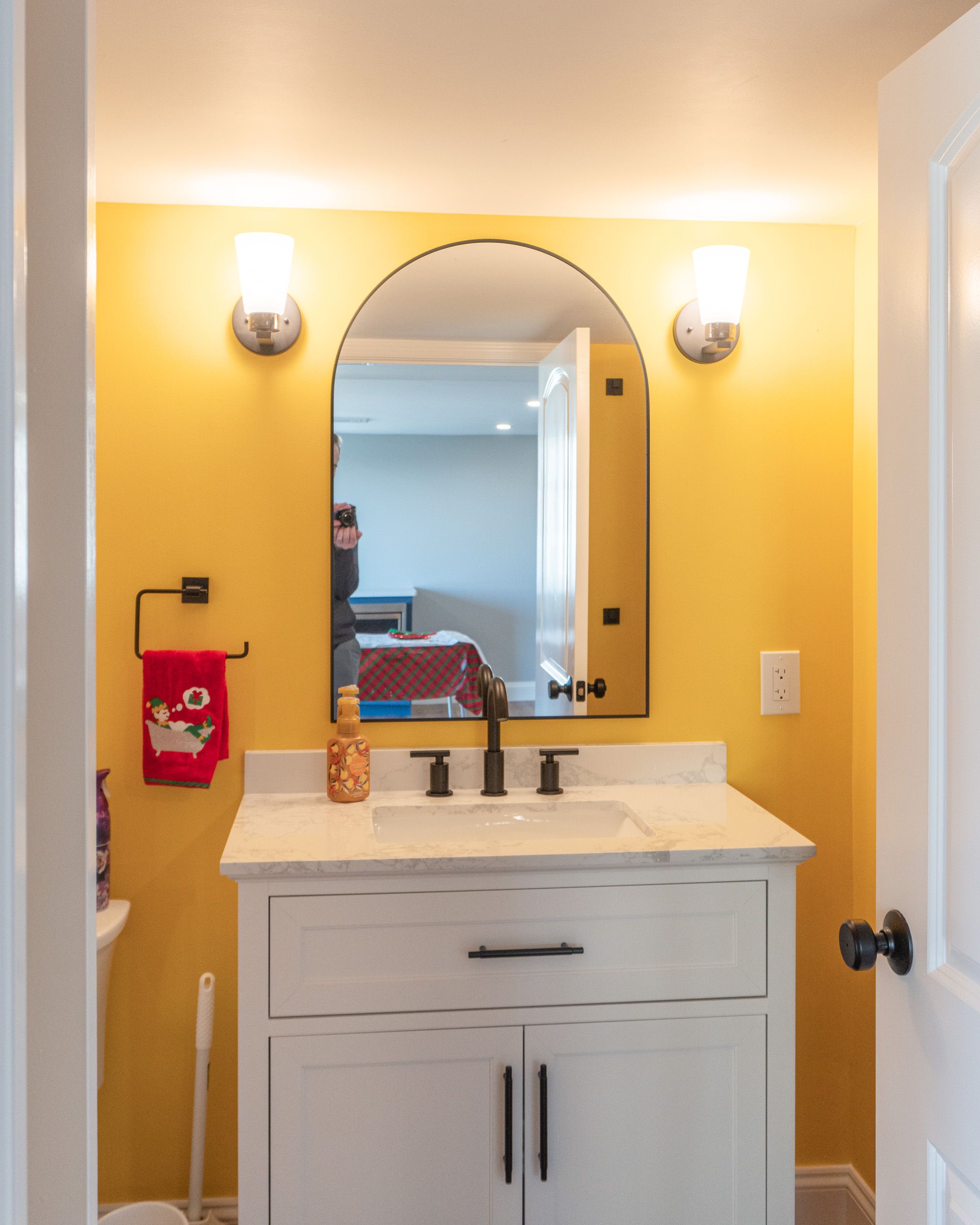 Vanity in a bathroom with bright yellow walls