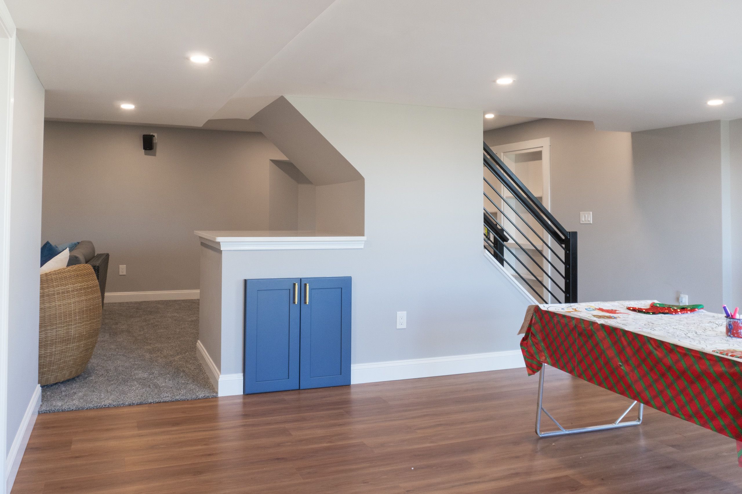 Blue cabinet doors under the stairs that give some extra storage room