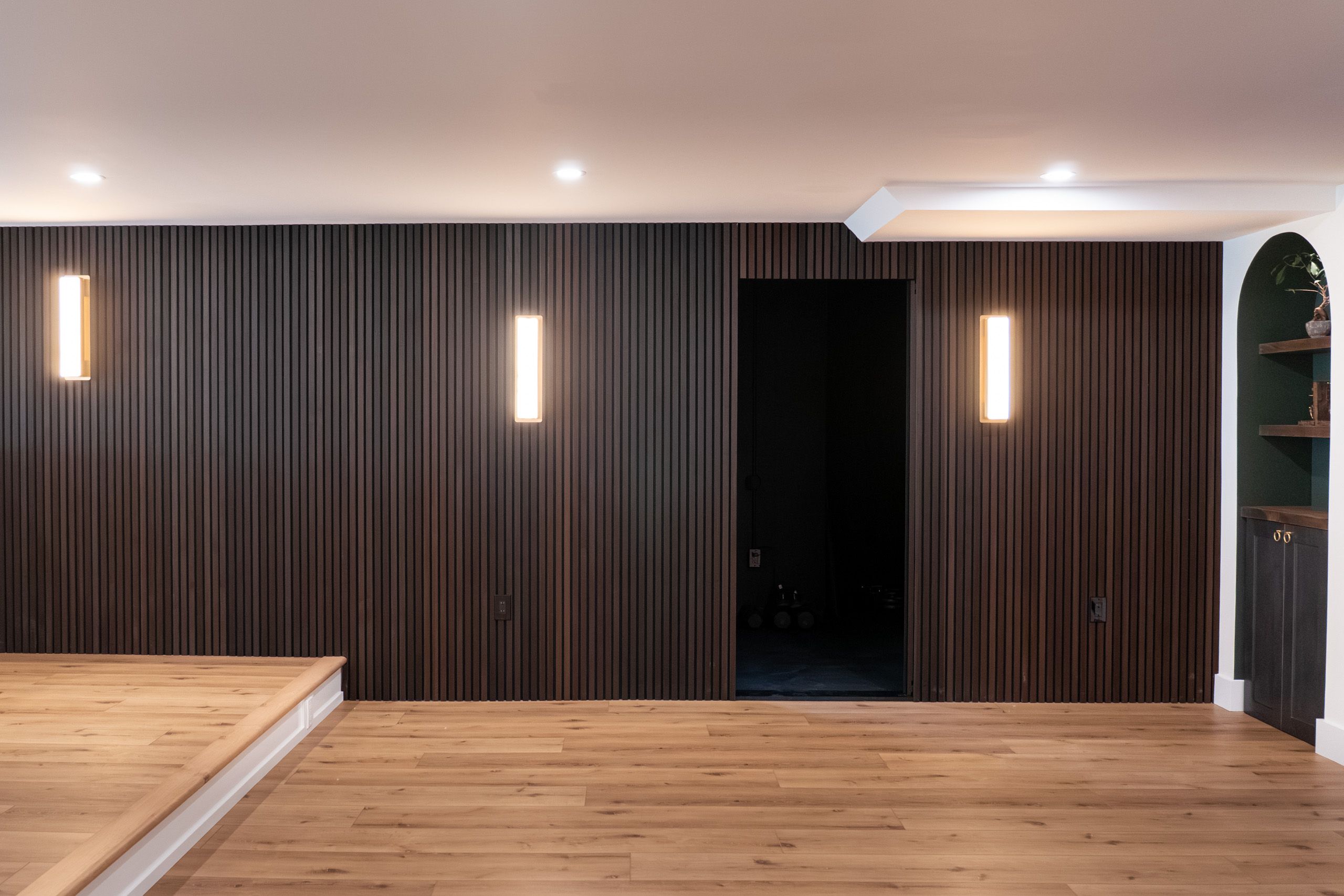 Hidden door open in fluted panel wall