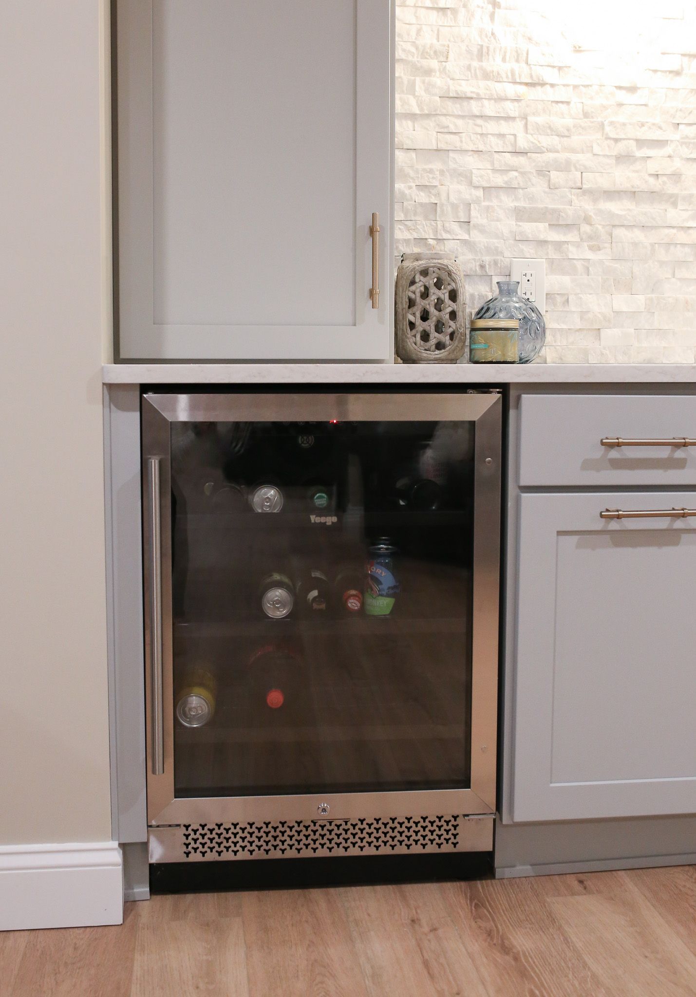 mini fridge built into the lower cabinets of a wet bar