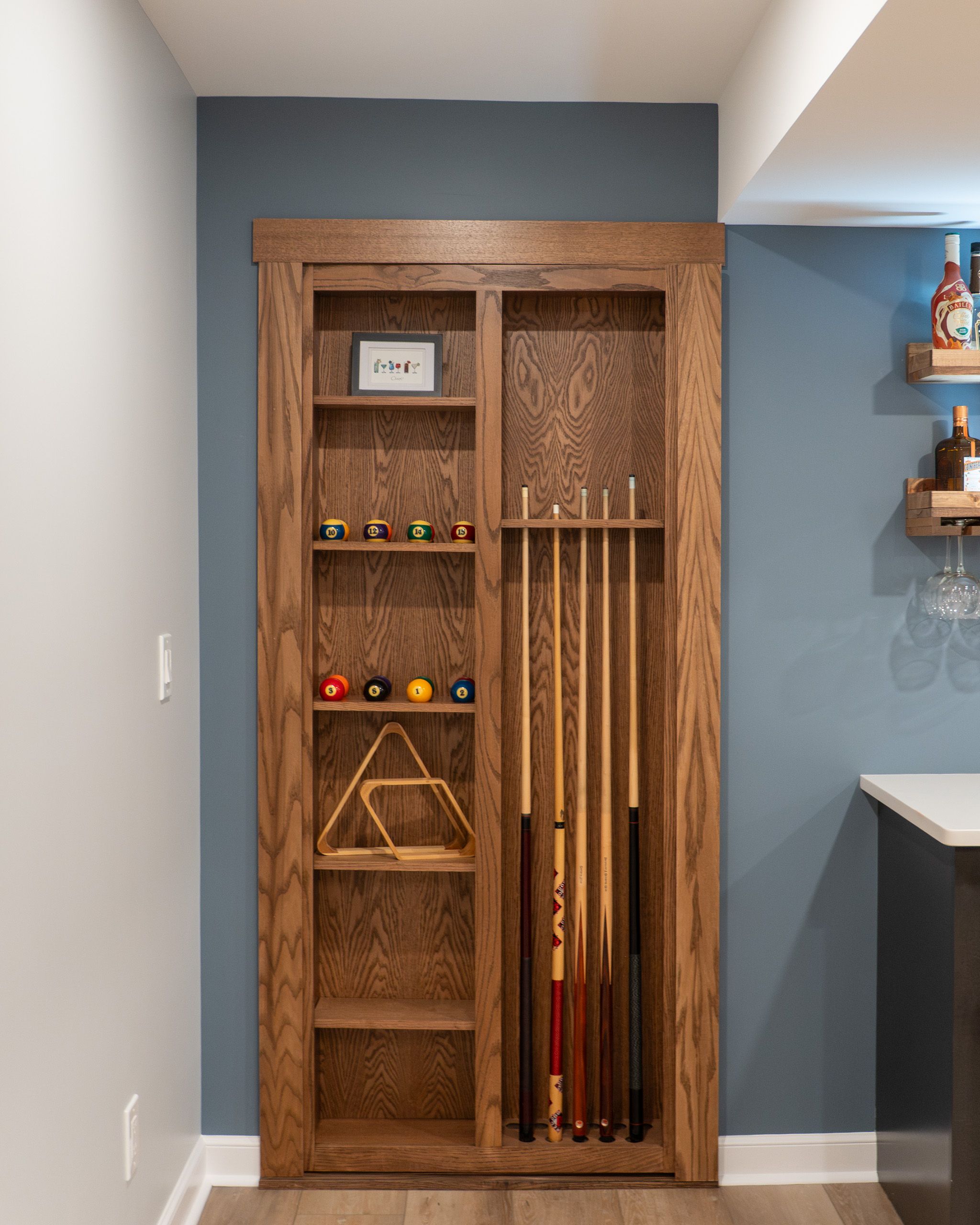 Pool cue rack hidden door