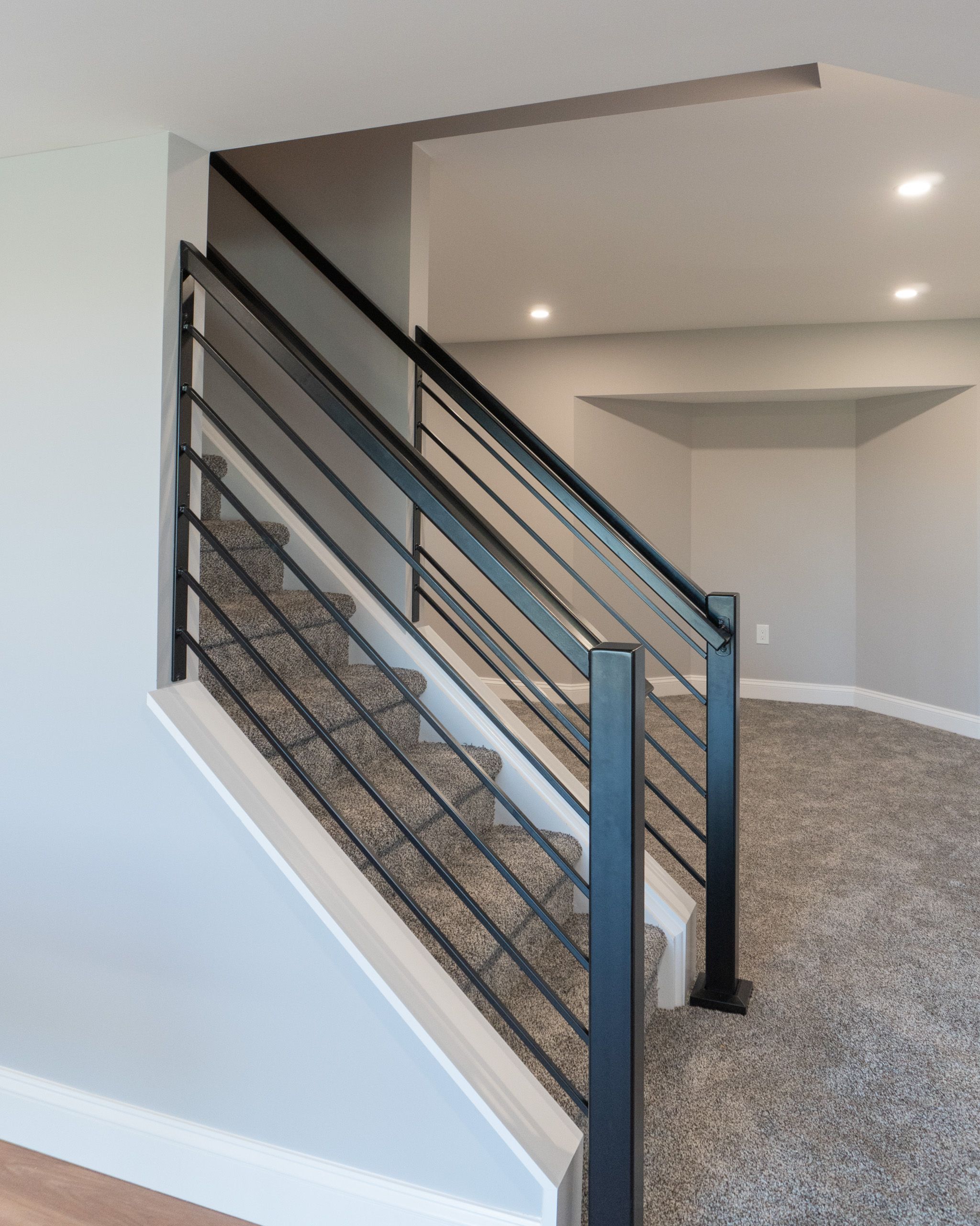 Black railing leading down to the basement