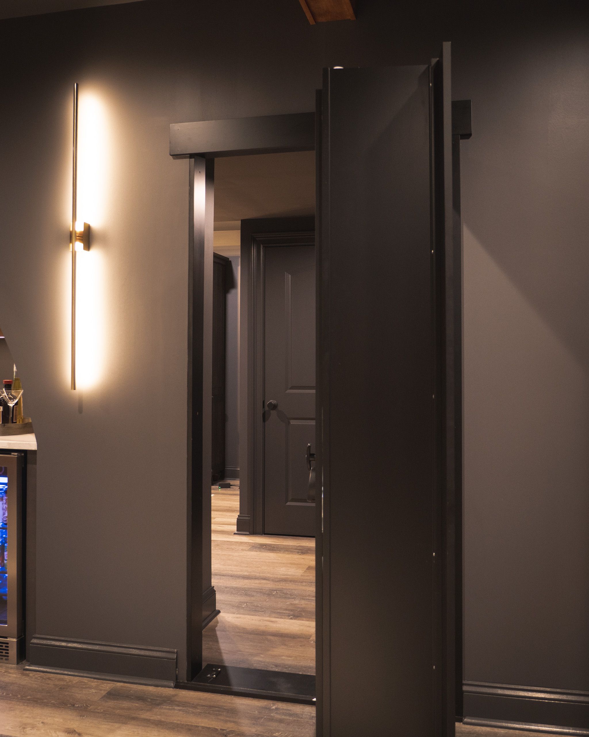 Hidden door open to reveal the whiskey lounge