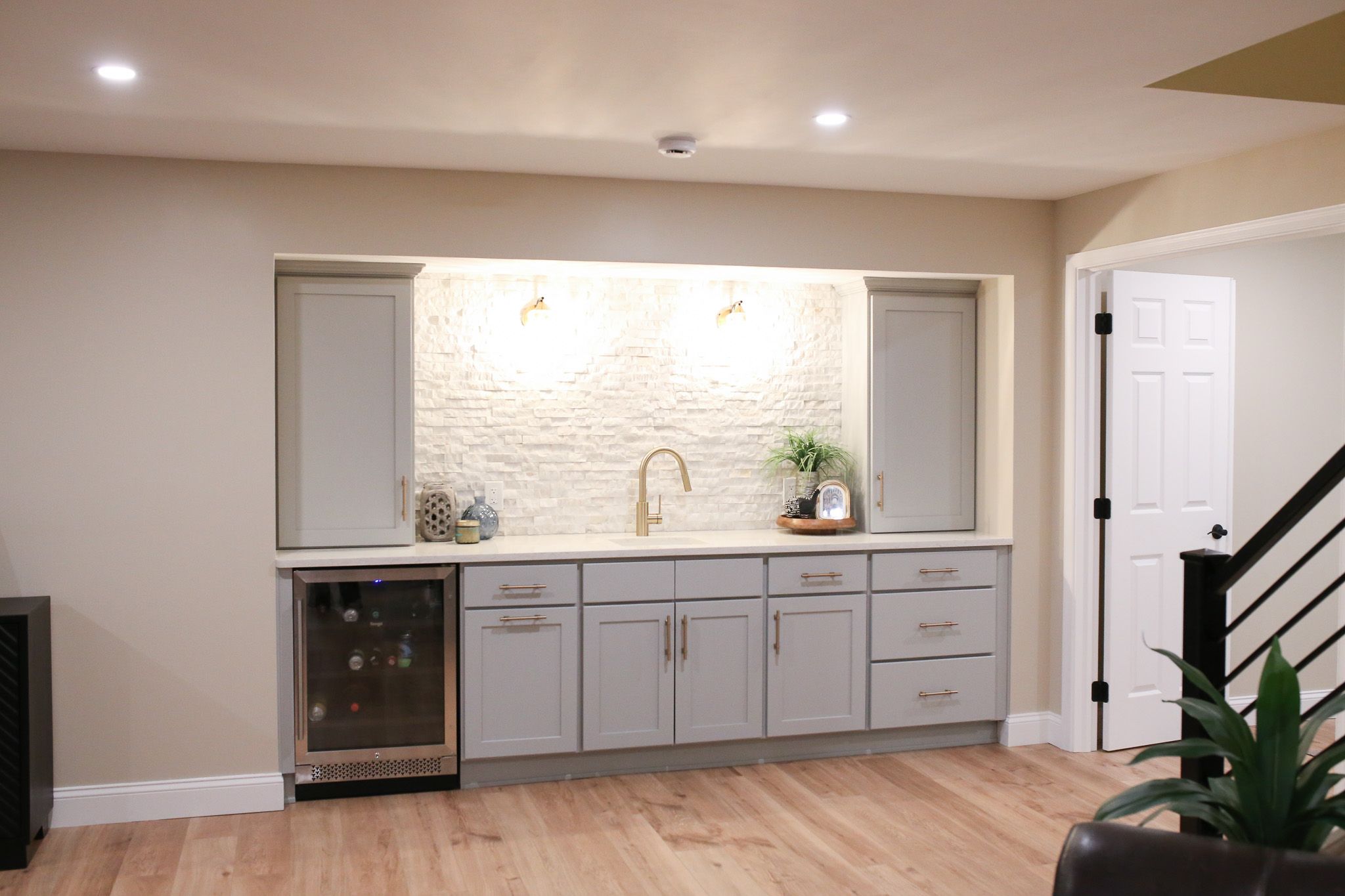 elegant wet war with sconce lights above the sink