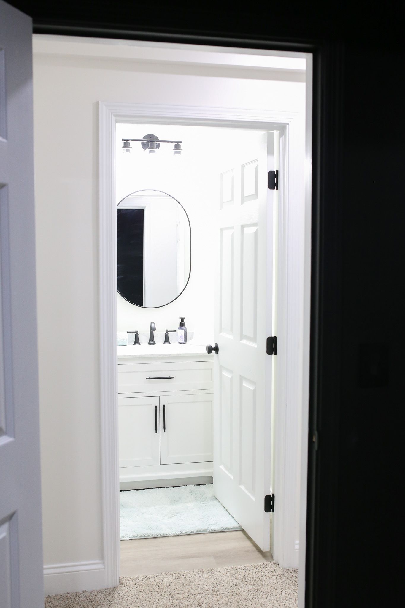 Vanity and mirror in a white bathroom