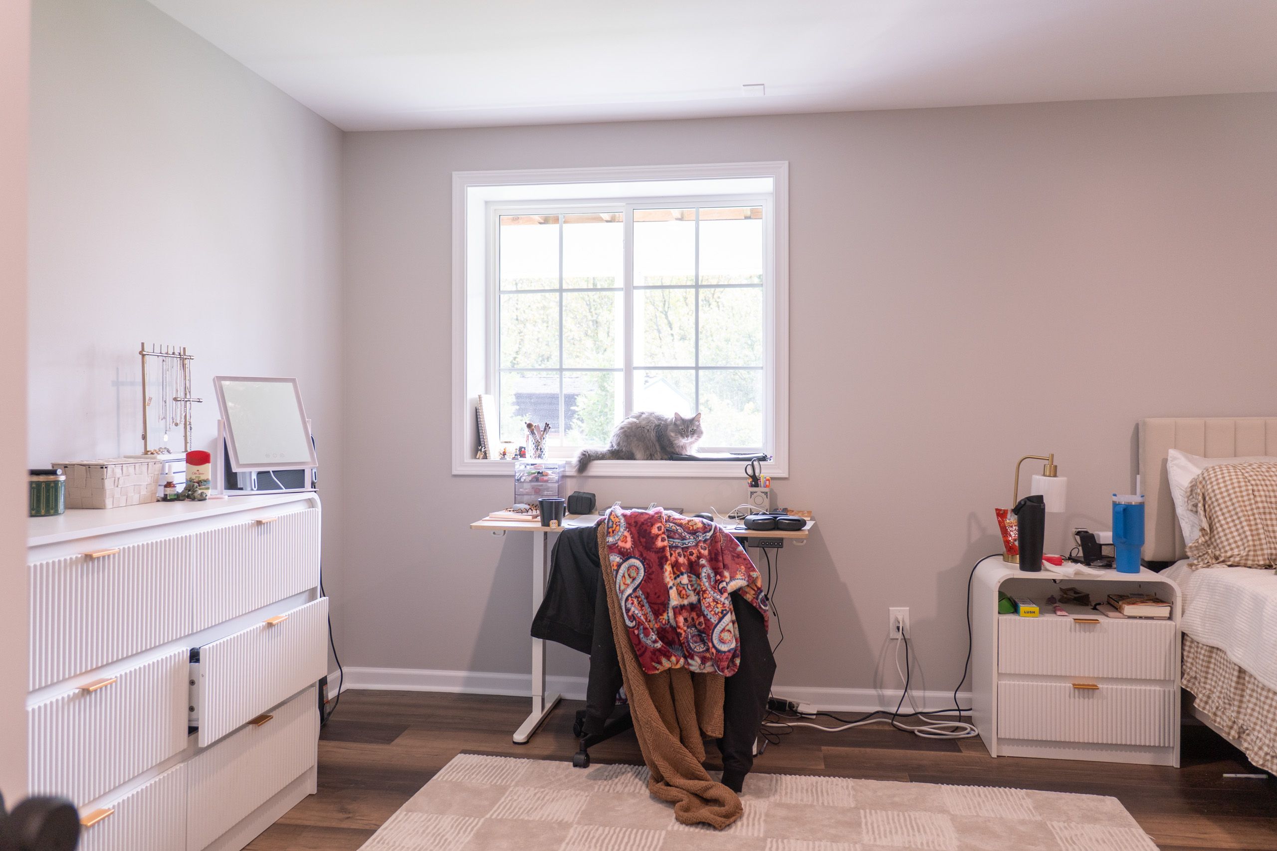 Bedroom with cat sitting on the windowsill