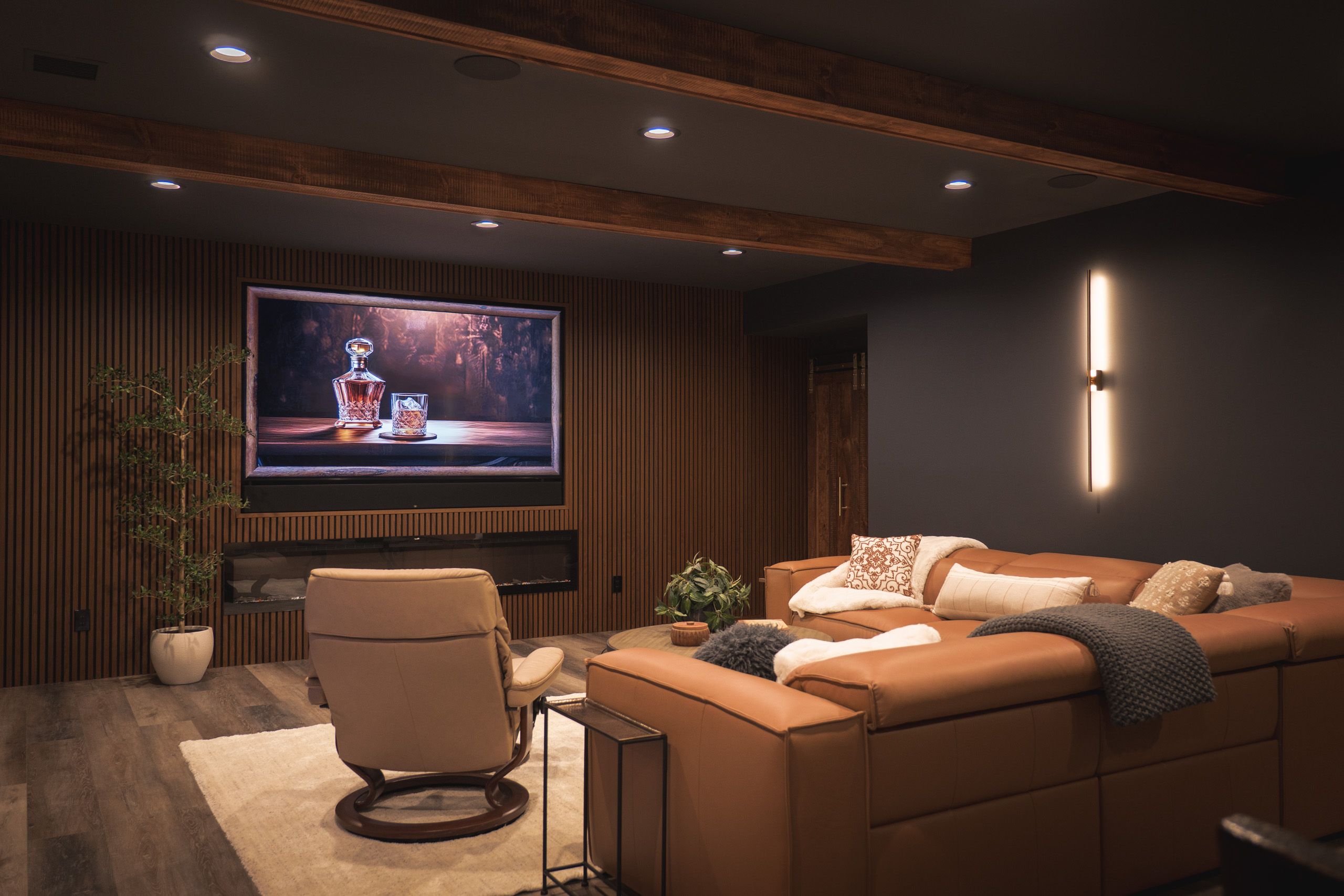 Entertainment center with fireplace in a dark, moody basement