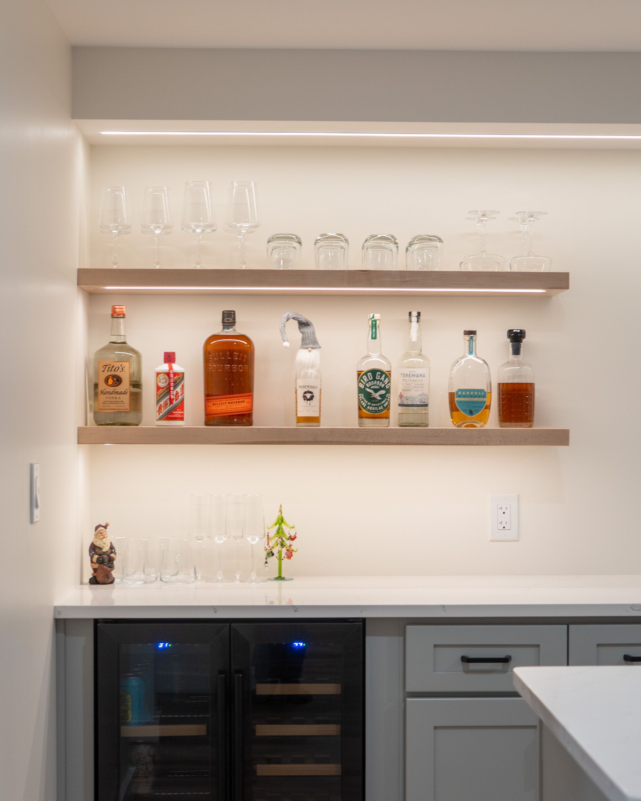 Floating shelves above the wet bar