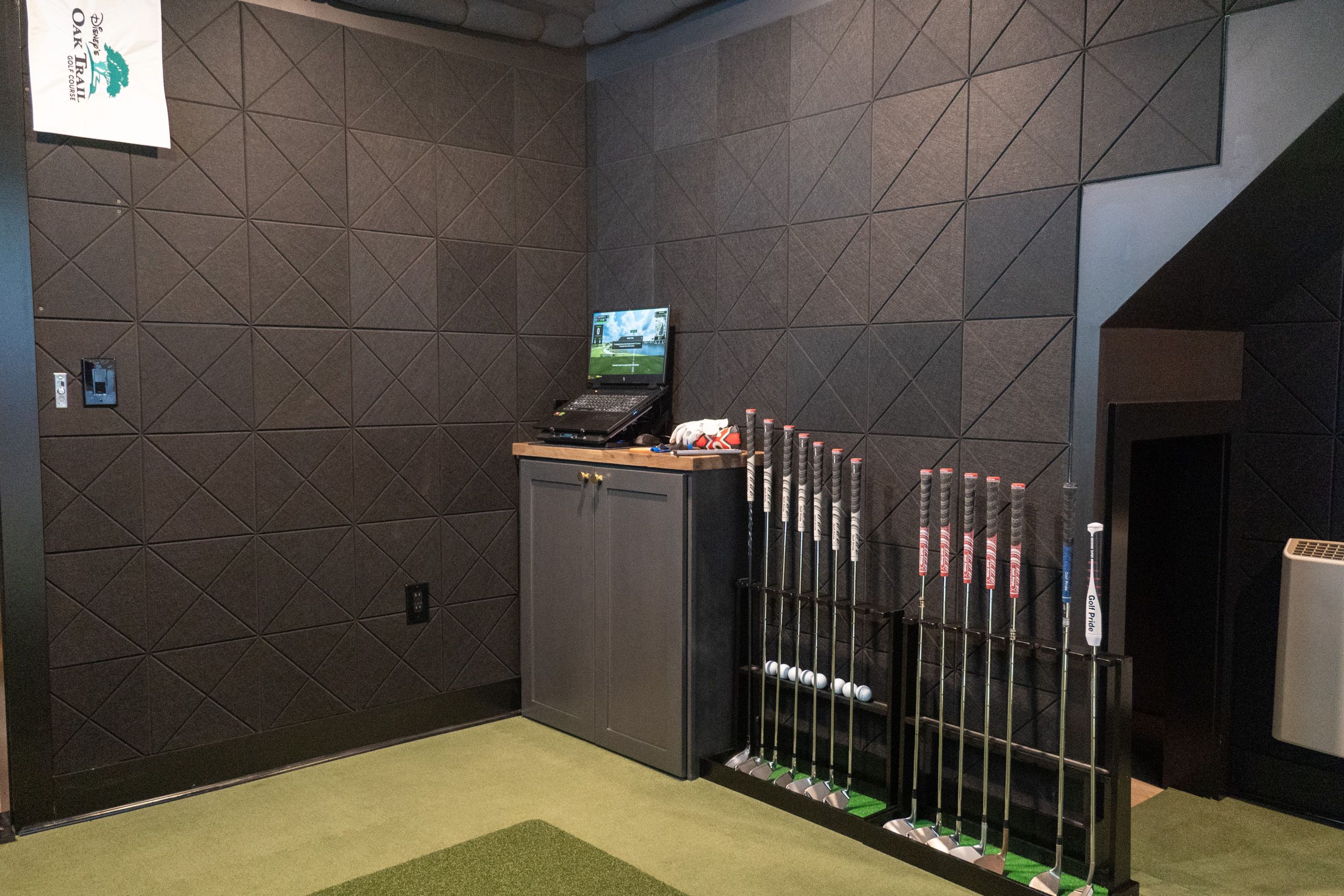 Laptop and clubs in the golf sim room