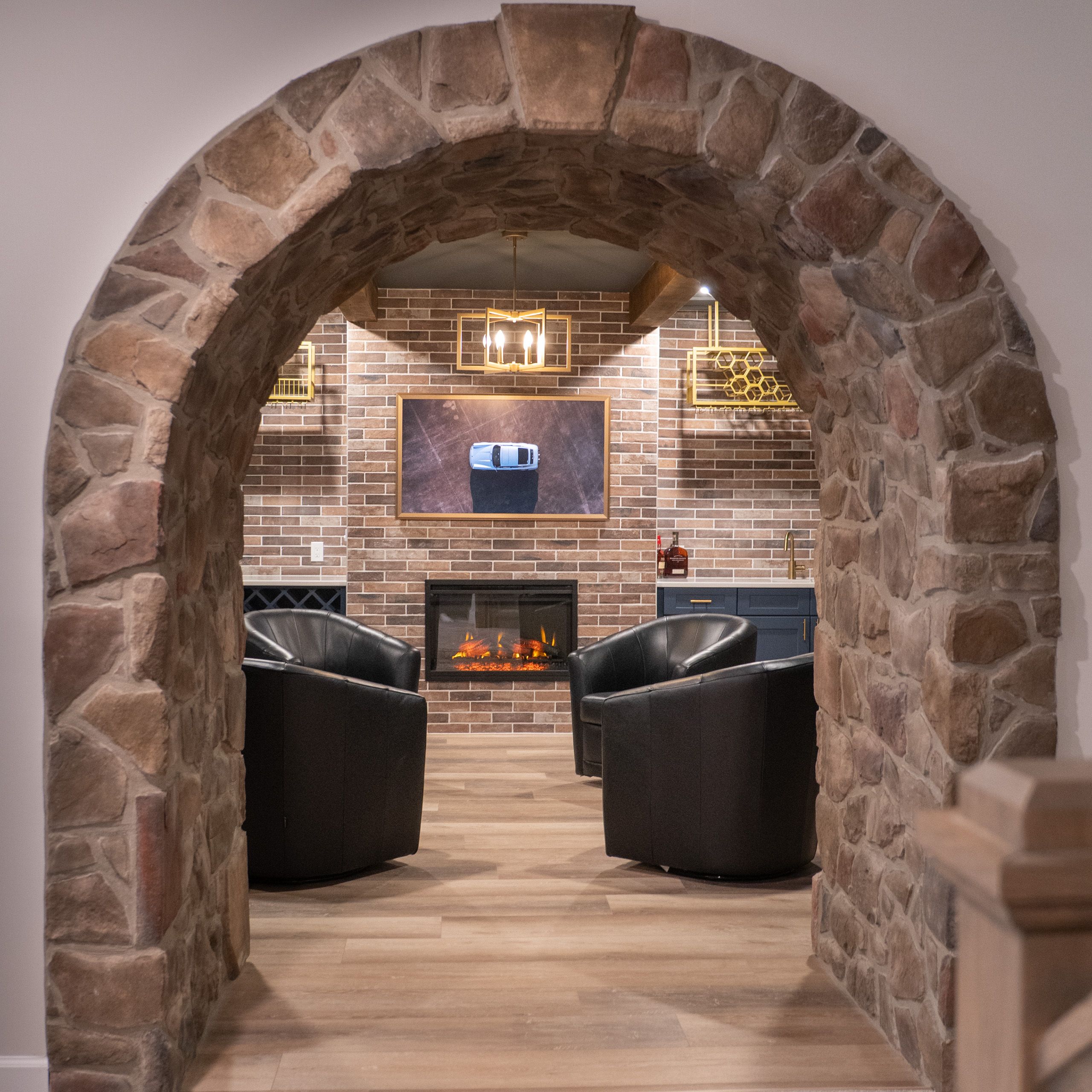 Stone arch leading into a room with a TV