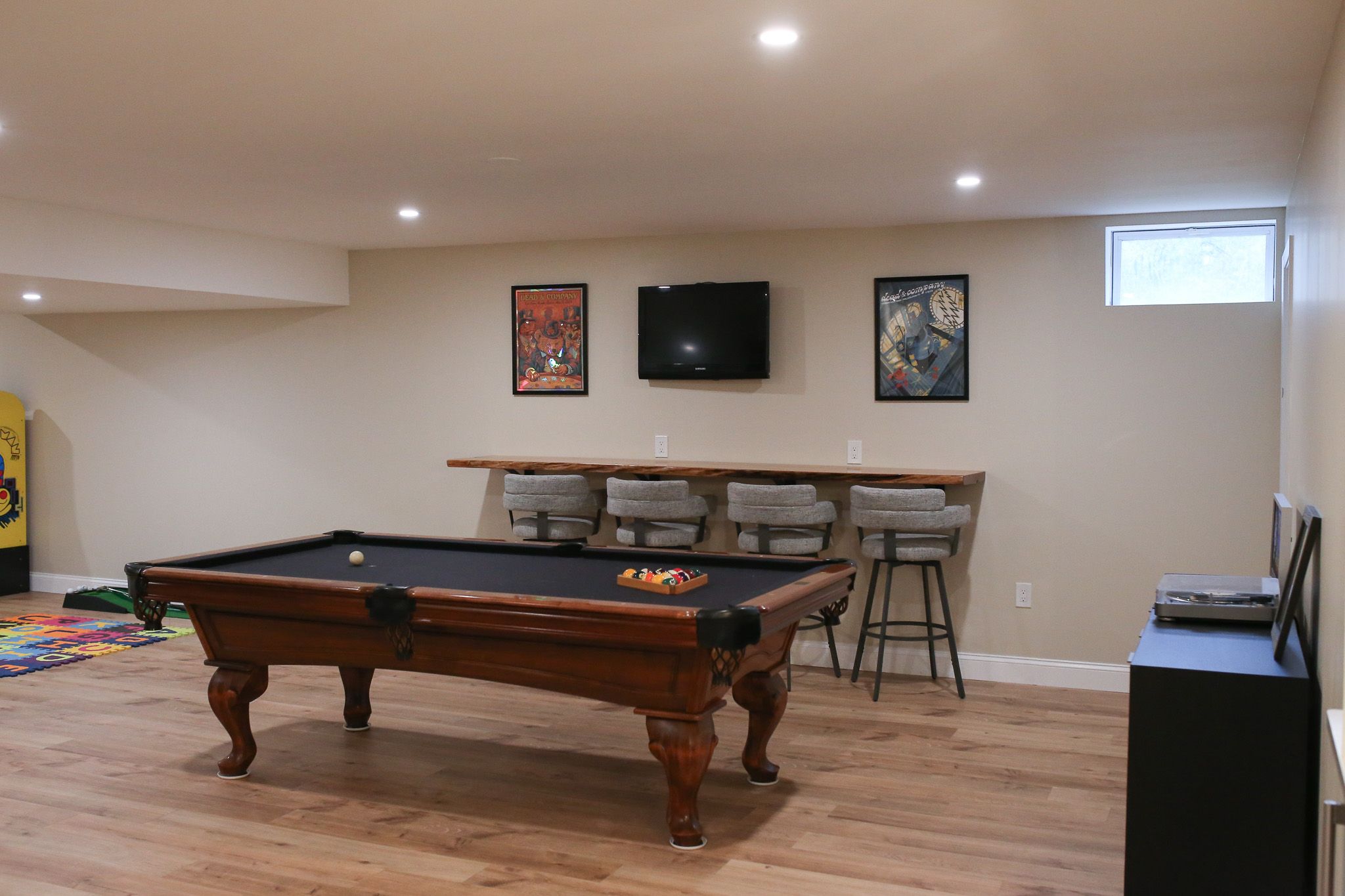 pool table with black fabric in a newly finished basement