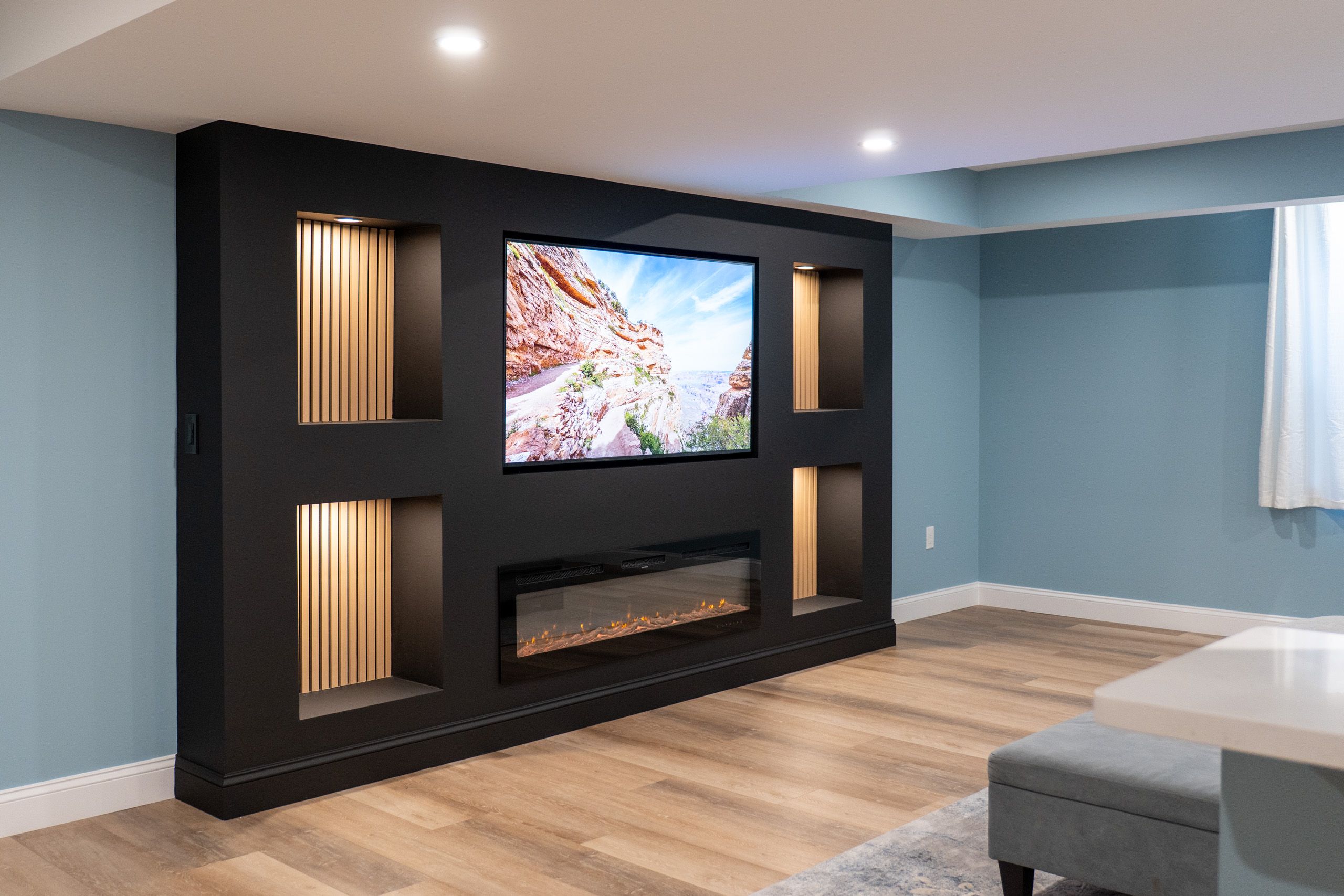 Black TV wall with fireplace in newly finished basement
