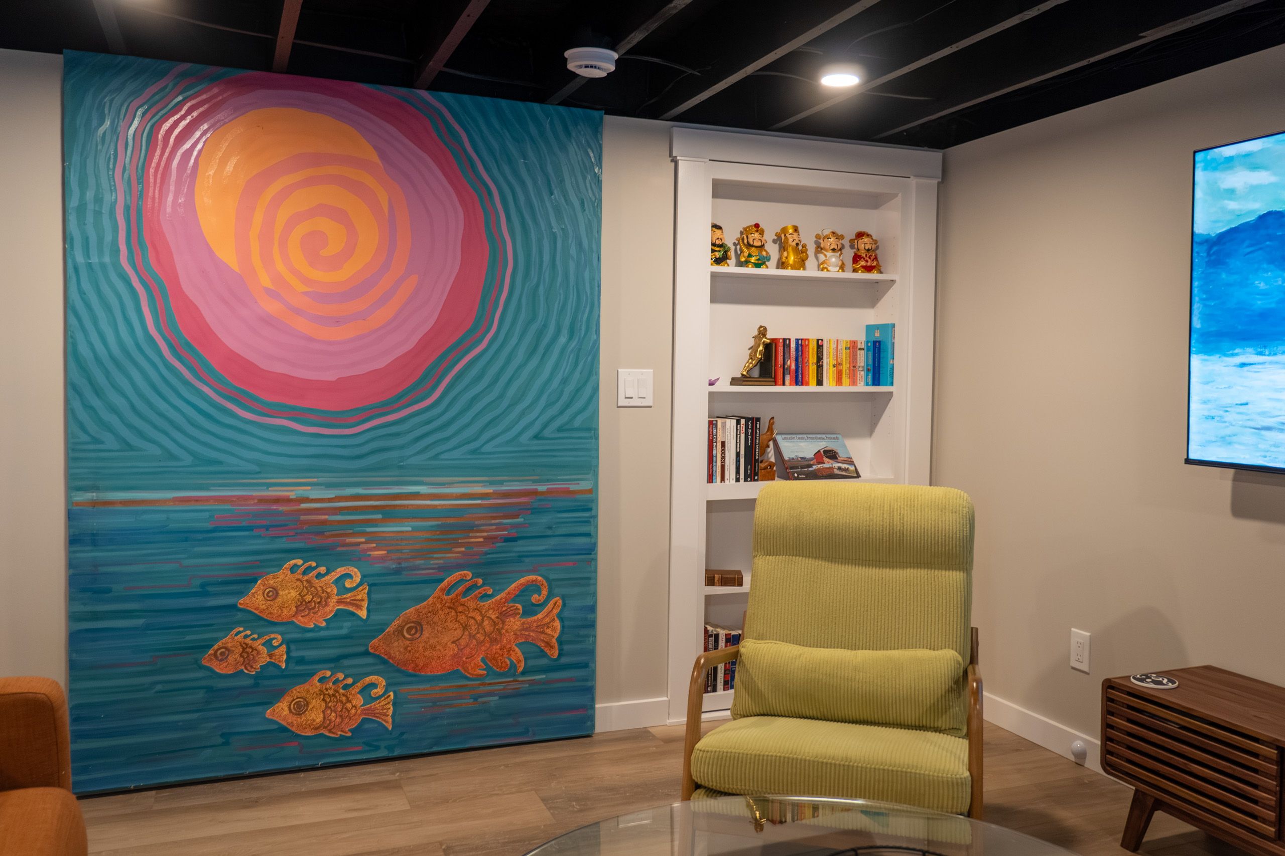 Wall with large painting and hidden bookcase door