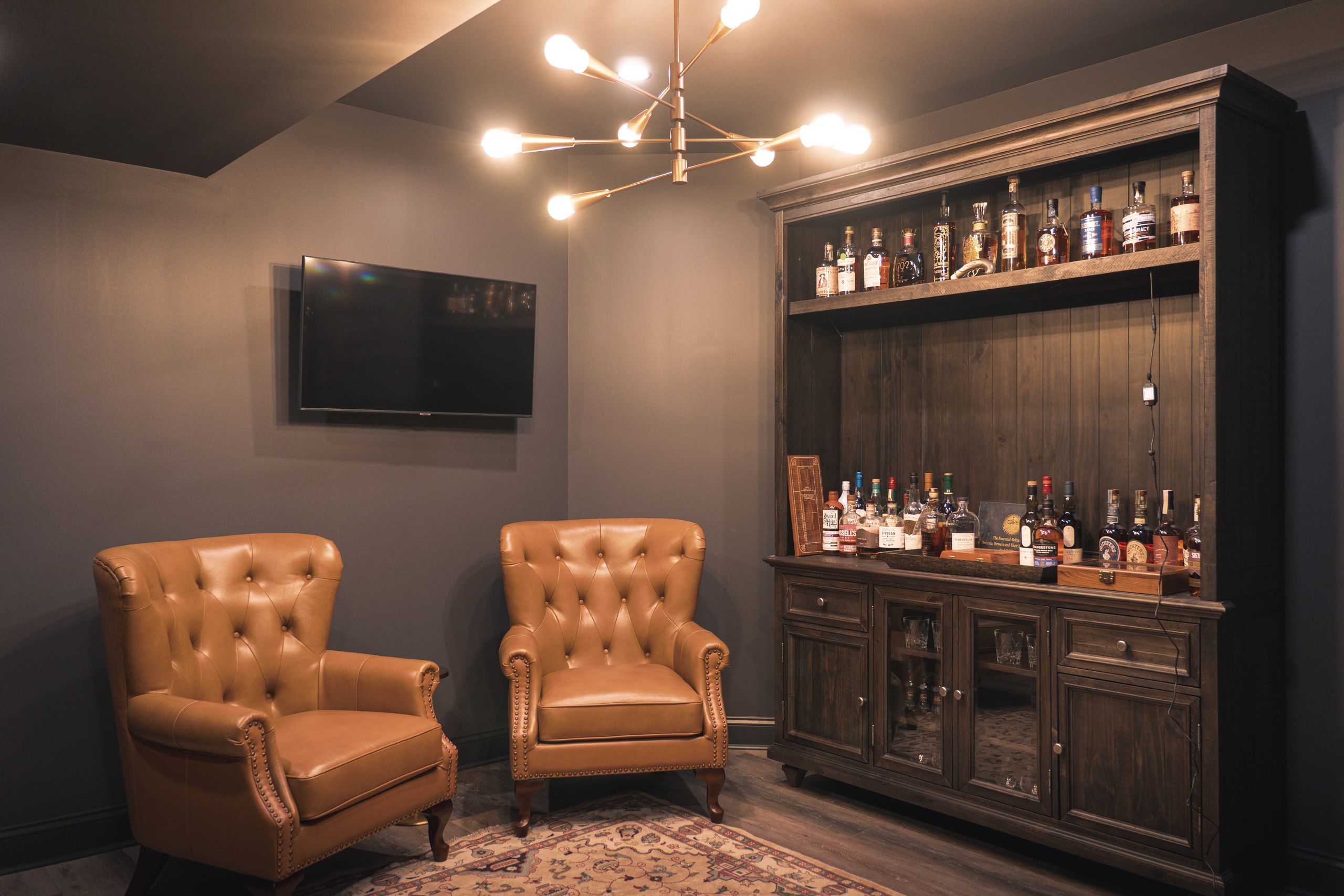 Whiskey lounge with leather chairs and bar hutch