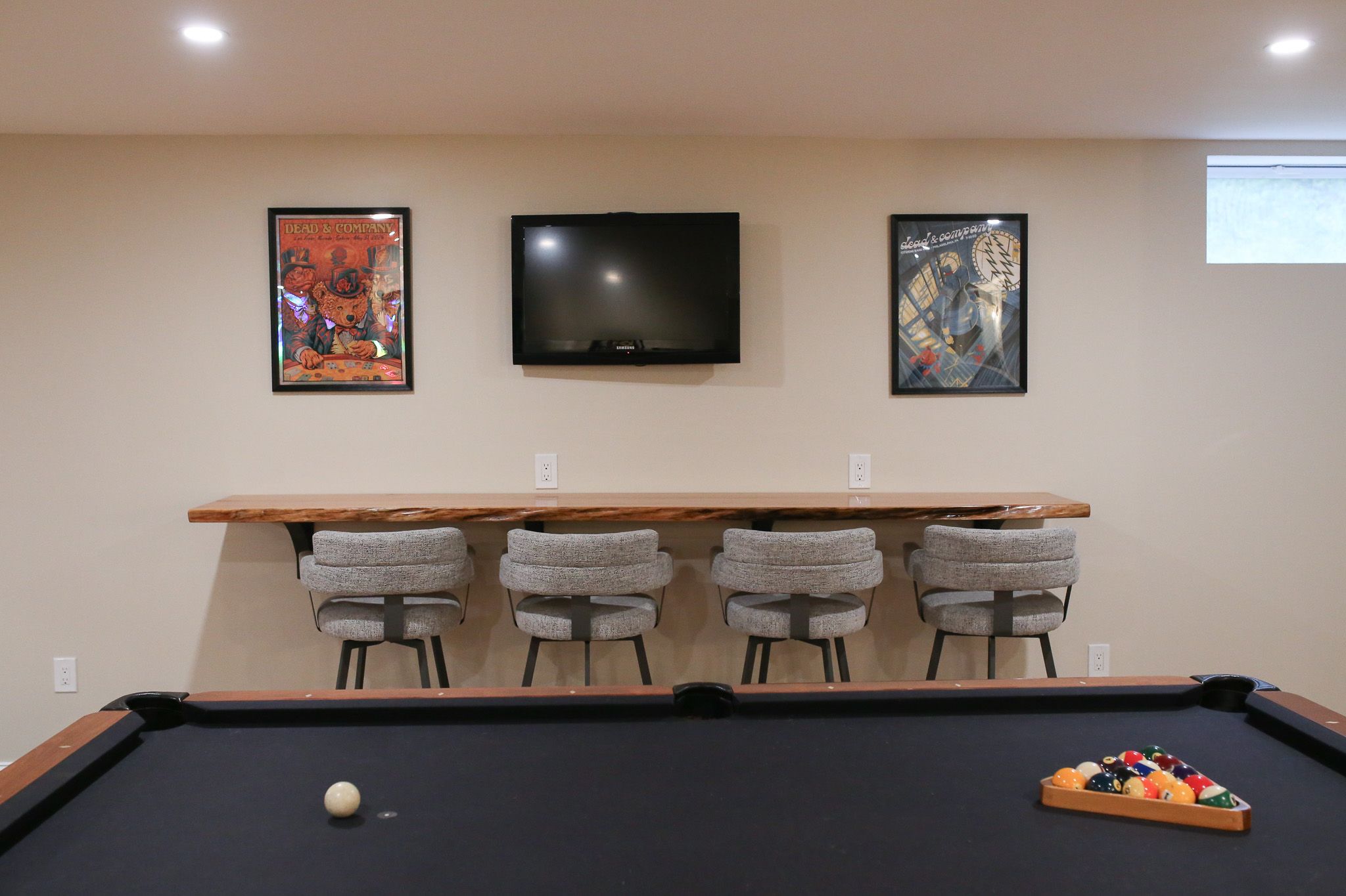 pool table with a TV on the wall behind it