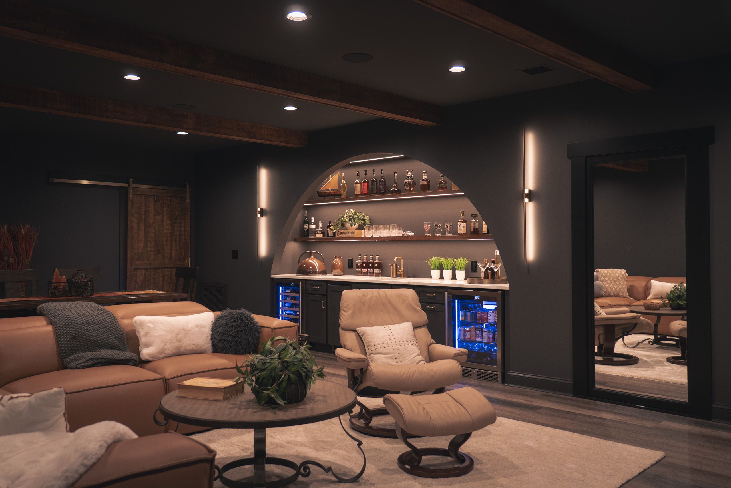 Dark, moody basement with arched wet bar