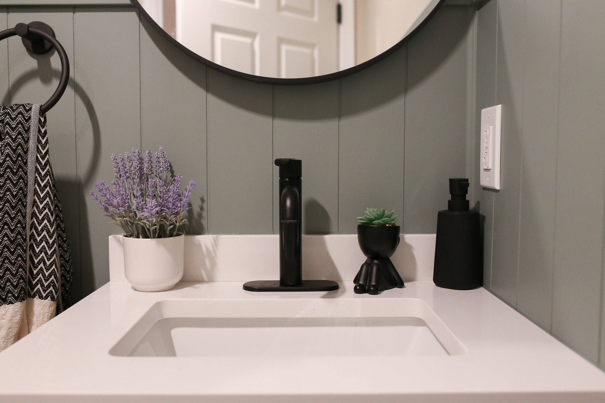 close up of the bathroom vanity top with a lavender plant and a succulent