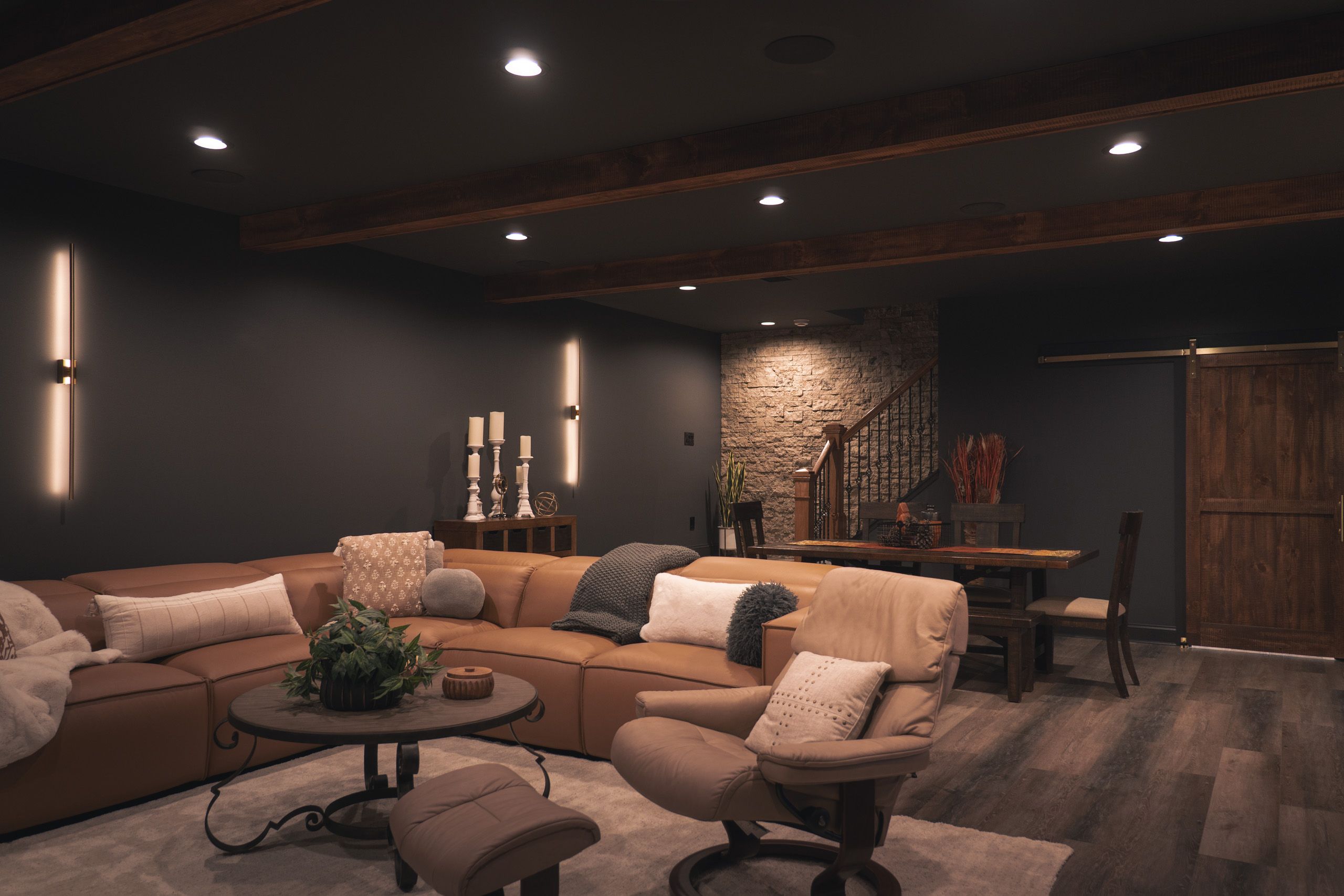 Dark, moody basement with leather couches