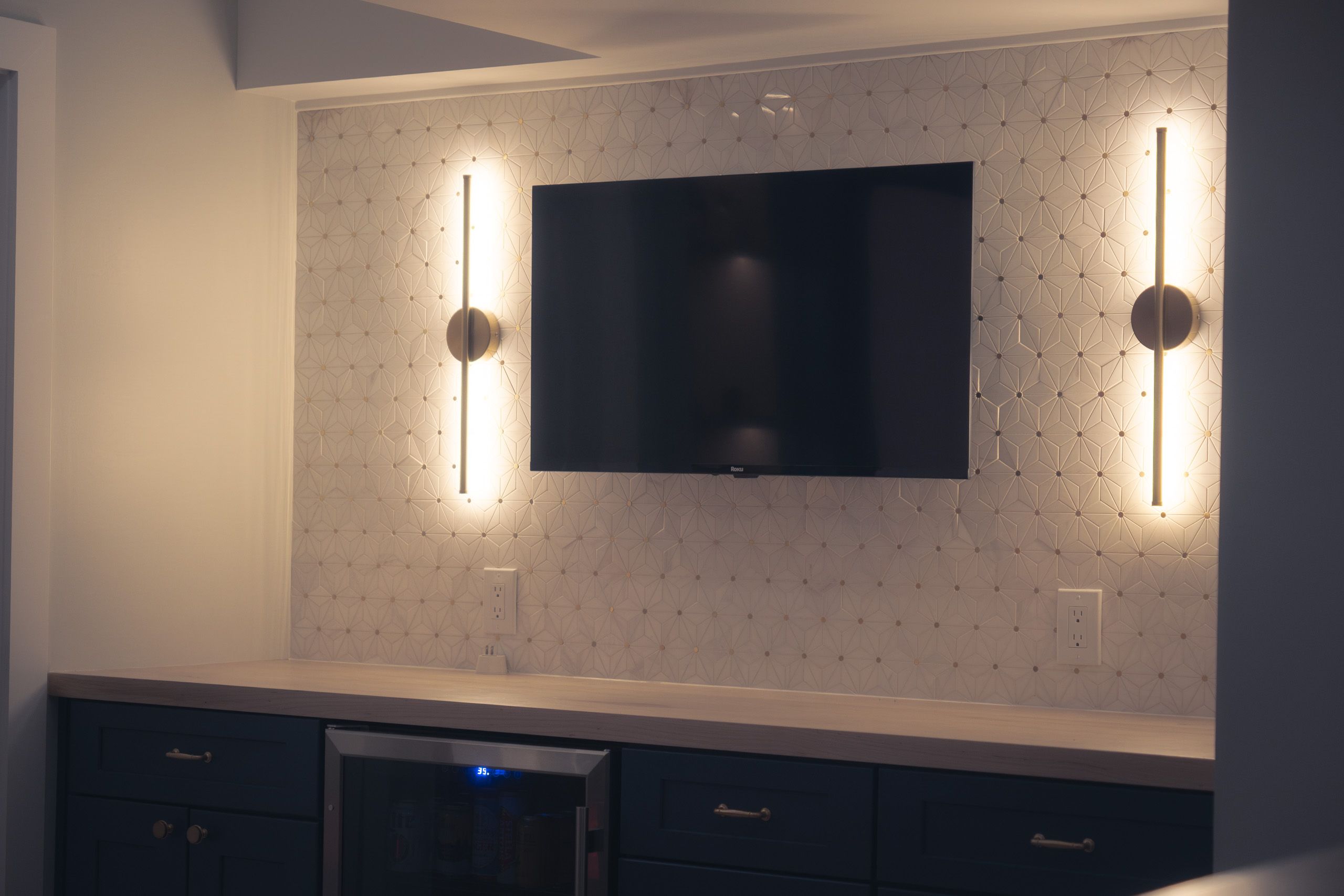 Dry bar with tile backsplash and sconce lights