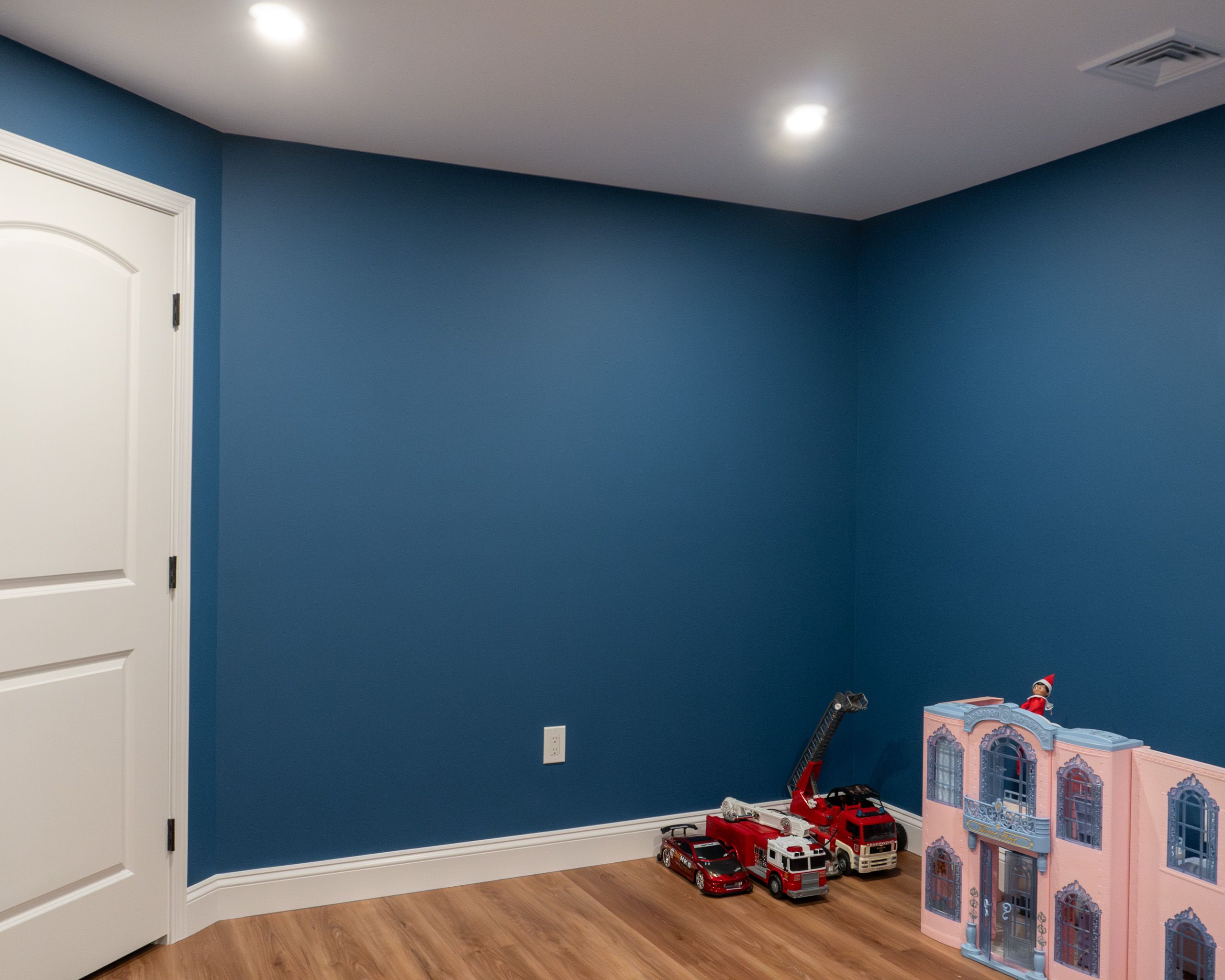 Playroom with blue walls in a newly remodeled basement