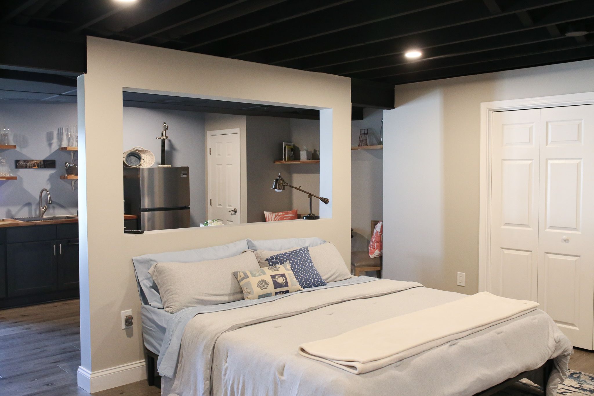 bed in the general living area of a basement