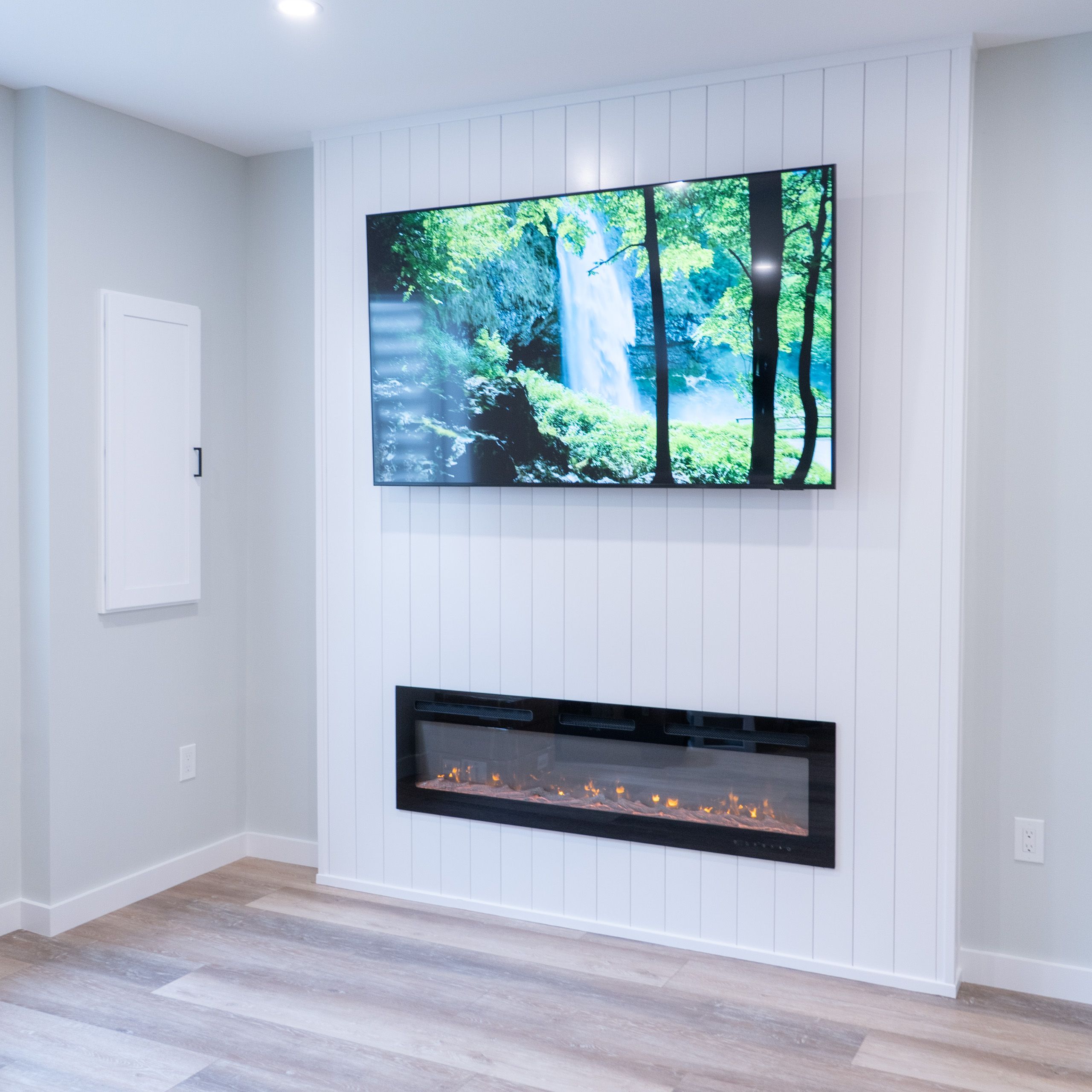 TV and fireplace on shiplap wall