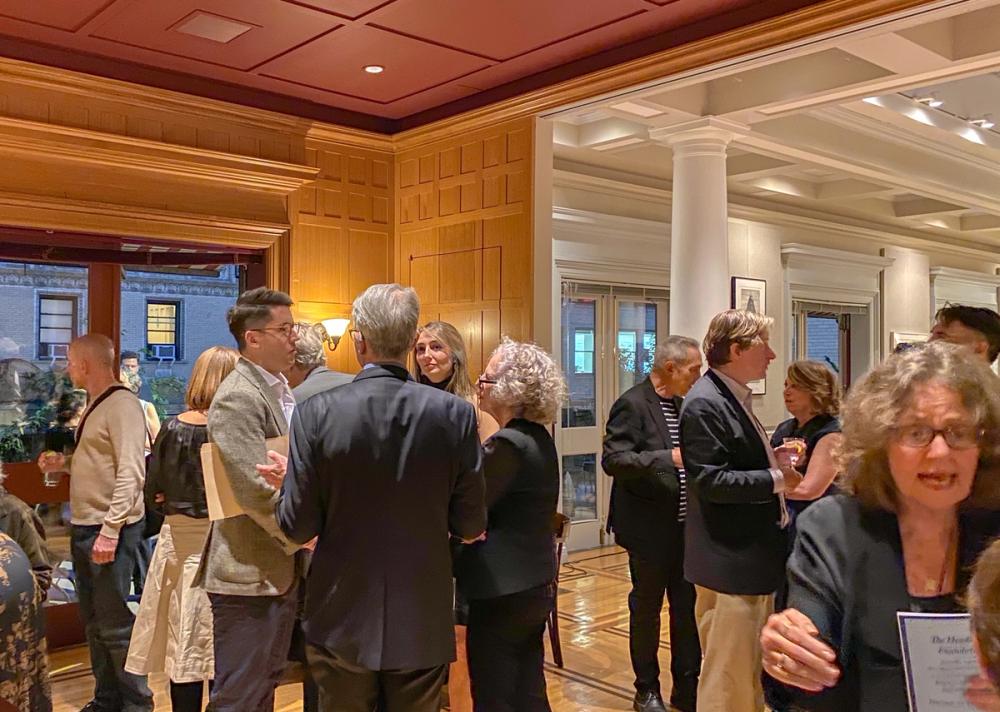 A photo of several people in conversation inside the event space at the Century Club.