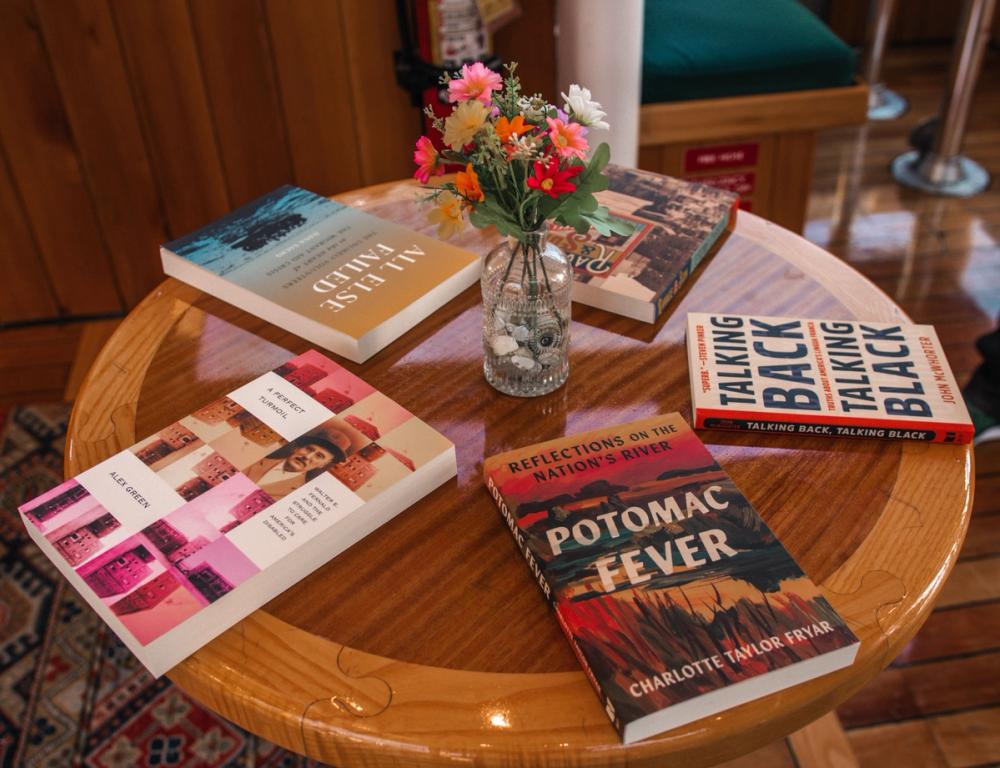 photo of five BLP books on a table arranged around a vase of flowers
