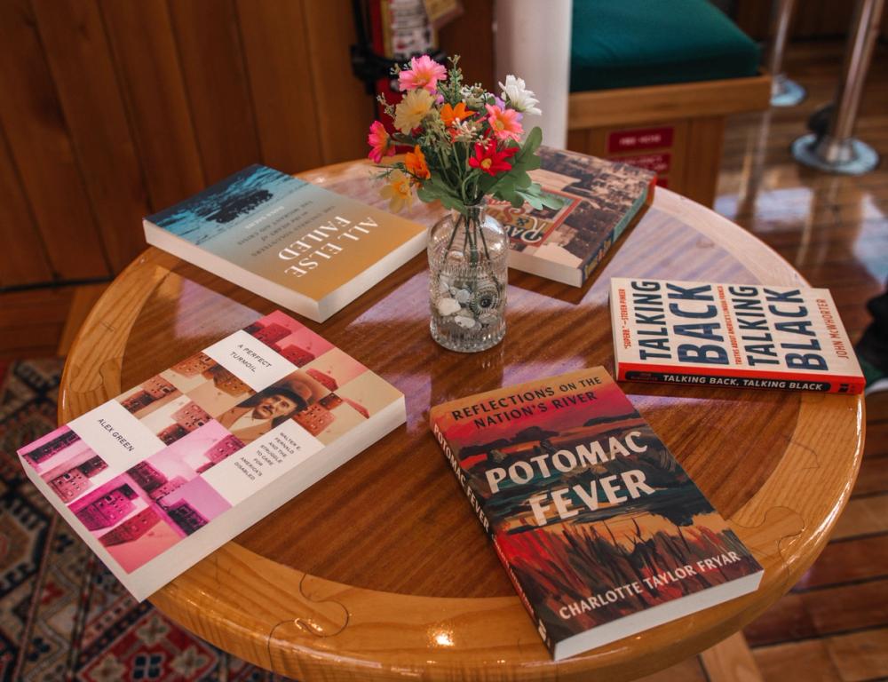 photo of five BLP books on a table arranged around a vase of flowers